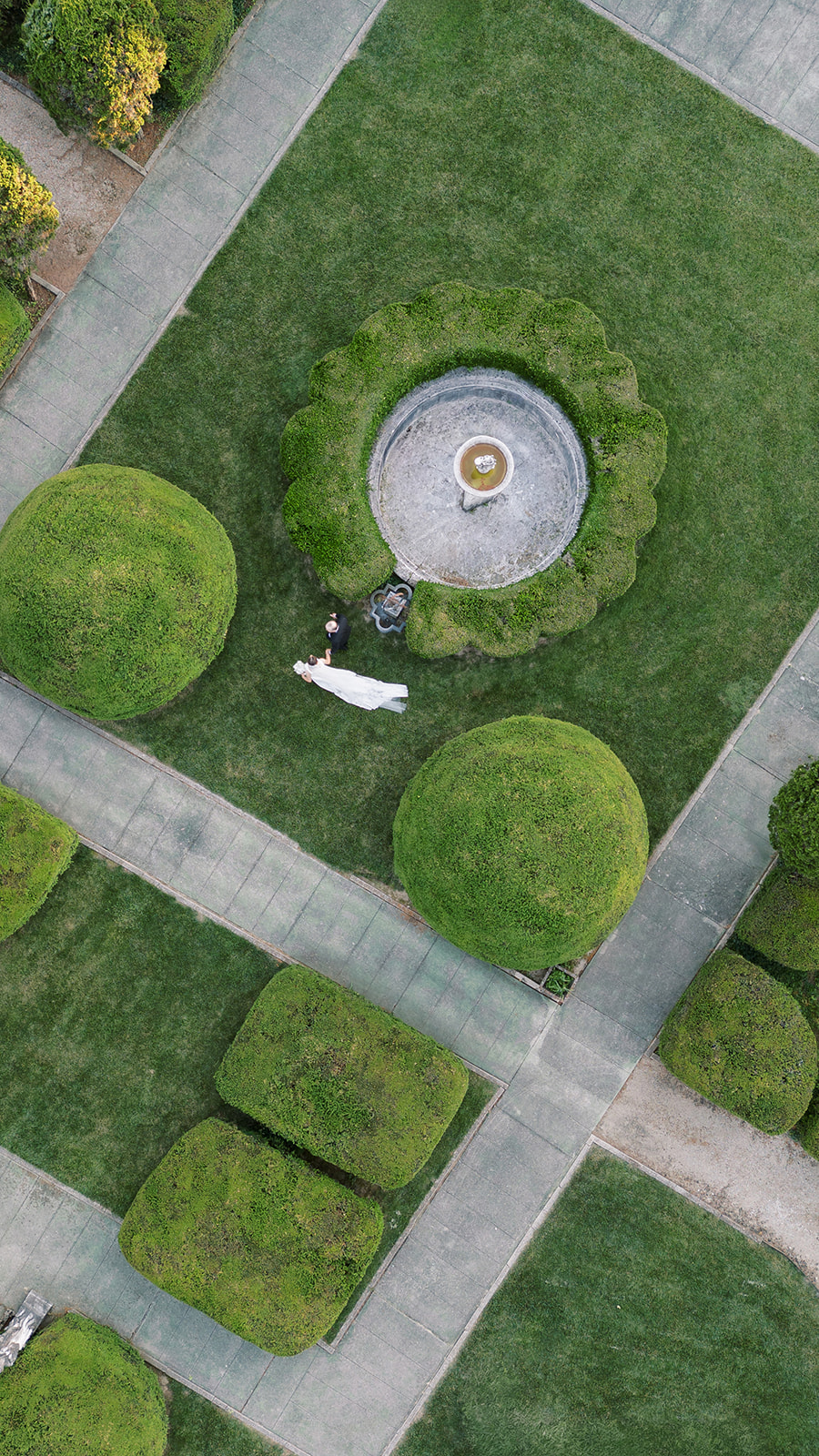 Aerial view of Michael and Julia among the formal gardens at Laurel Court
