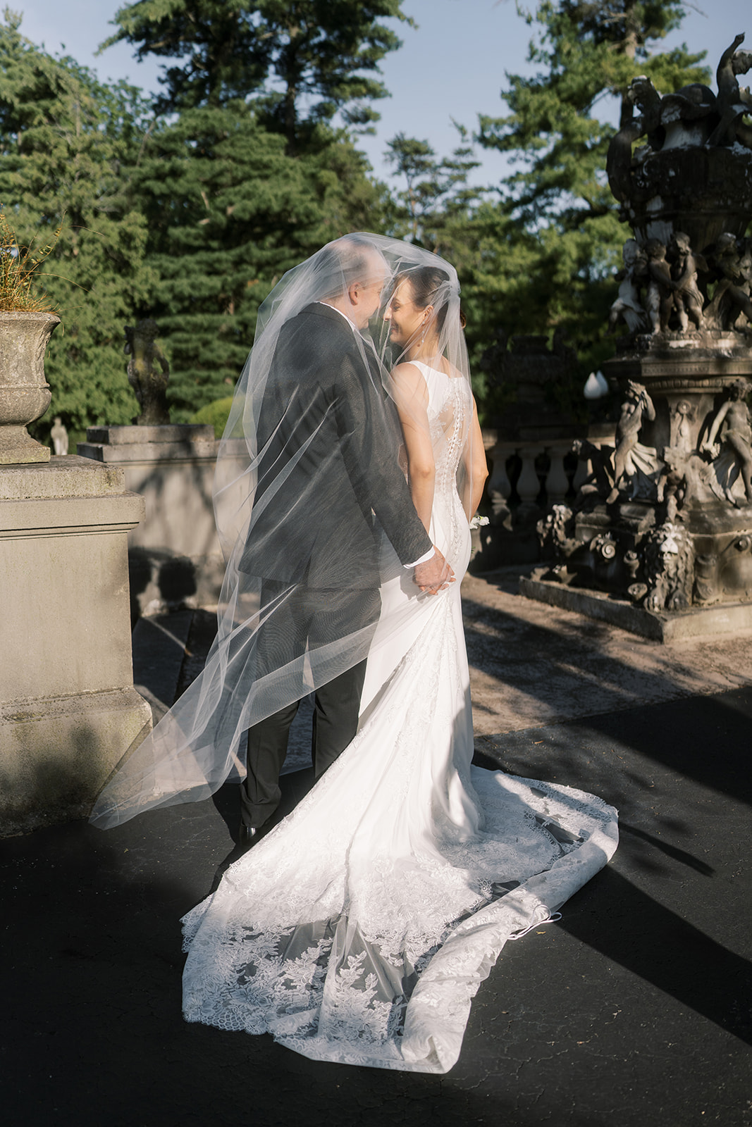 Black-and-white portrait of Michael and Julia embracing beneath Julia's veil