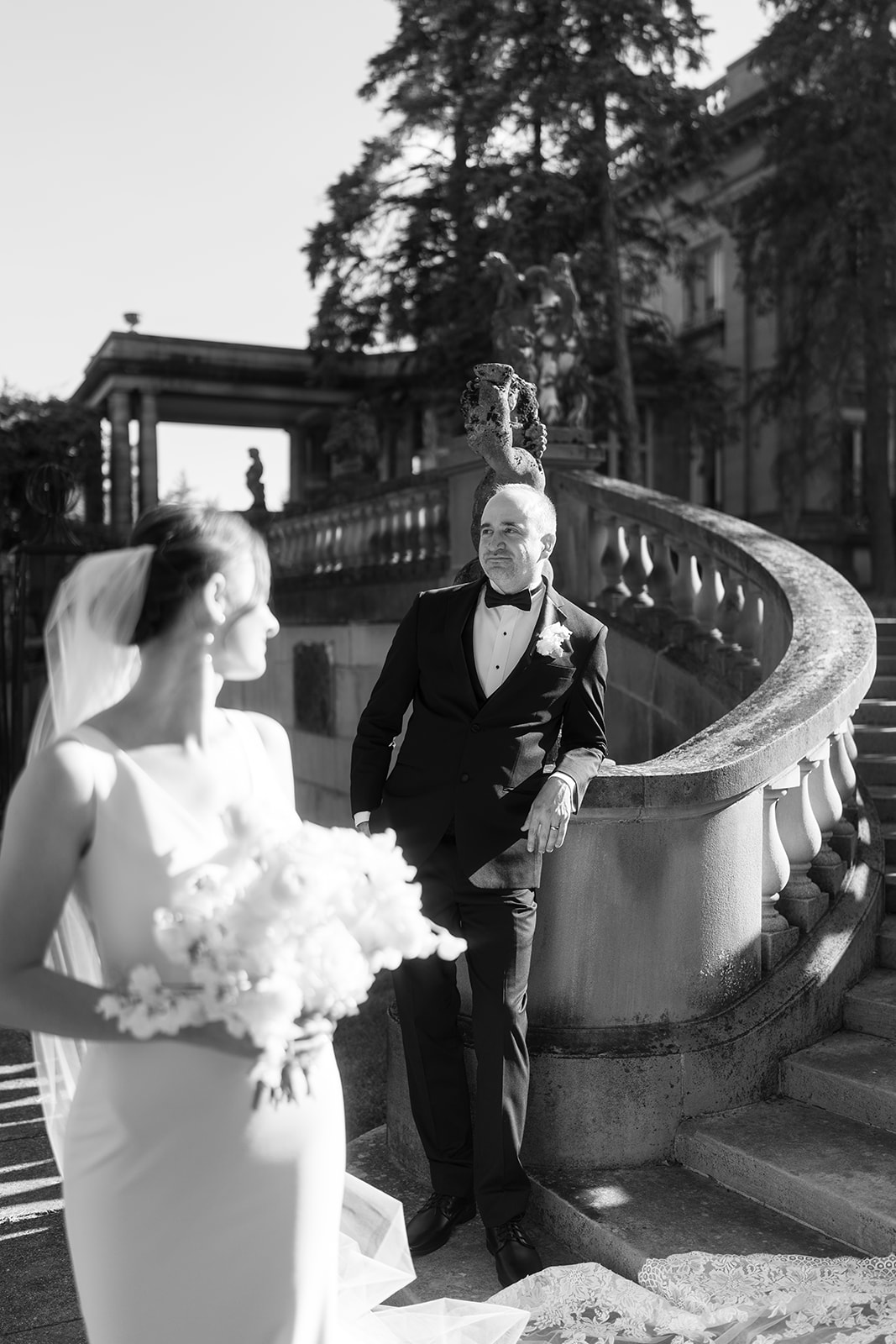 Michael and Julia walking down the curved stone staircase at Laurel Court