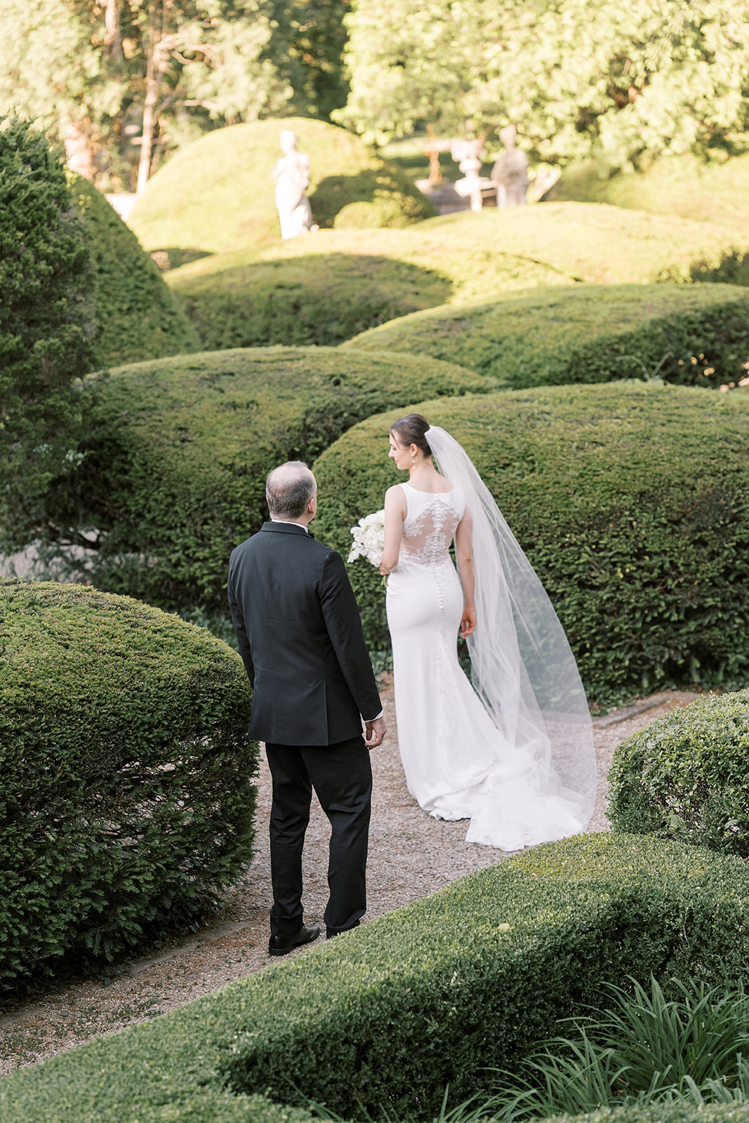 Michael and Julia walking through the formal hedged garden at Laurel Court