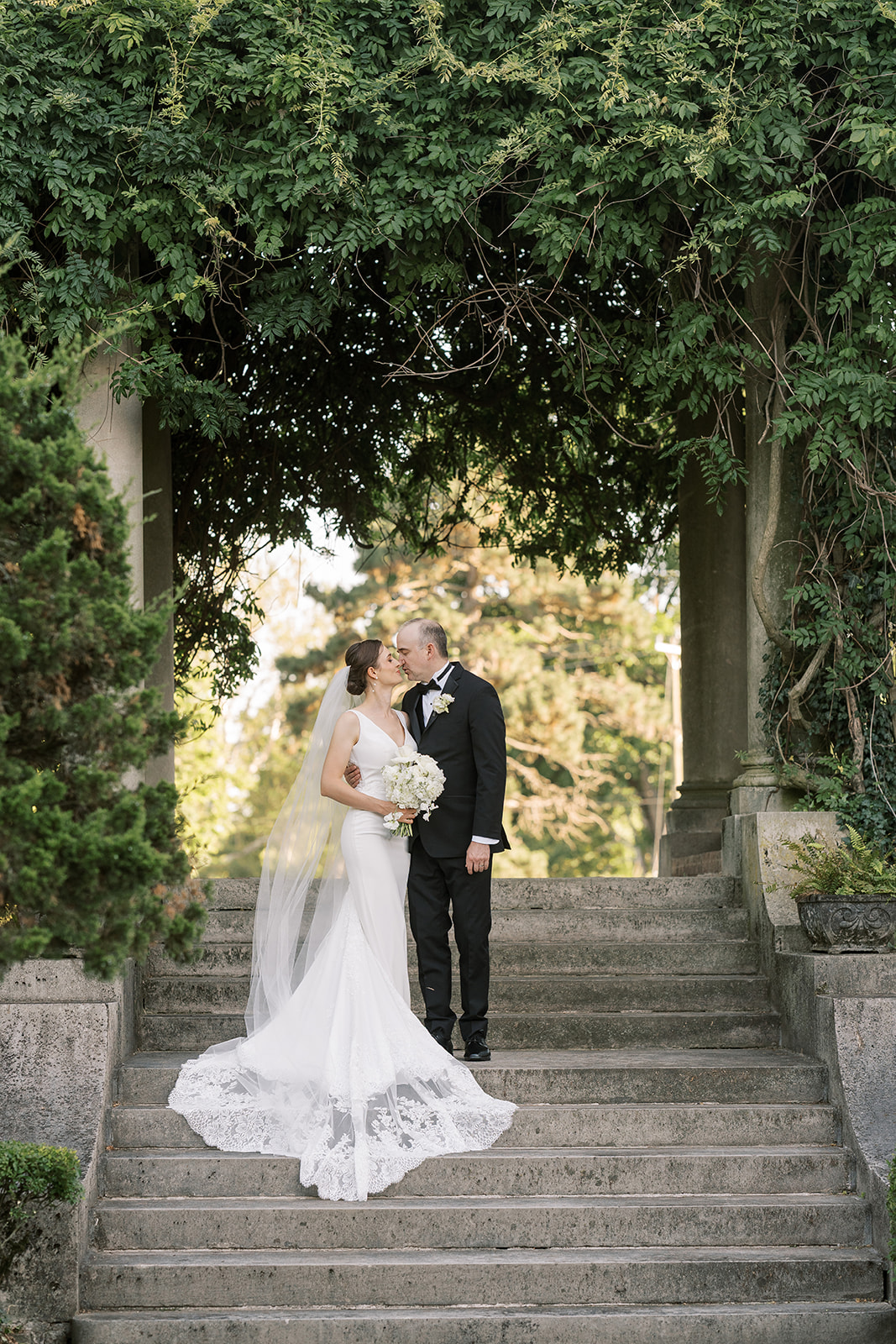 Michael and Julia posing together on a garden staircase at Laurel Court