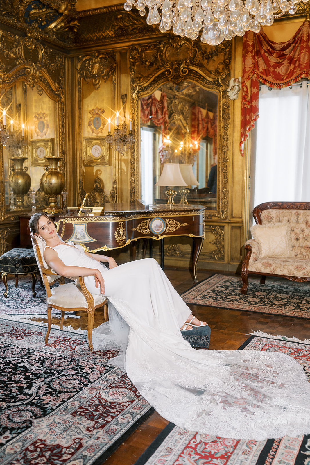 Michael and Julia seated together beneath the chandelier inside Laurel Court