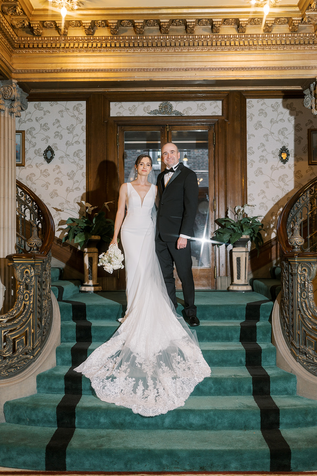 Michael and Julia together on the grand interior staircase at Laurel Court