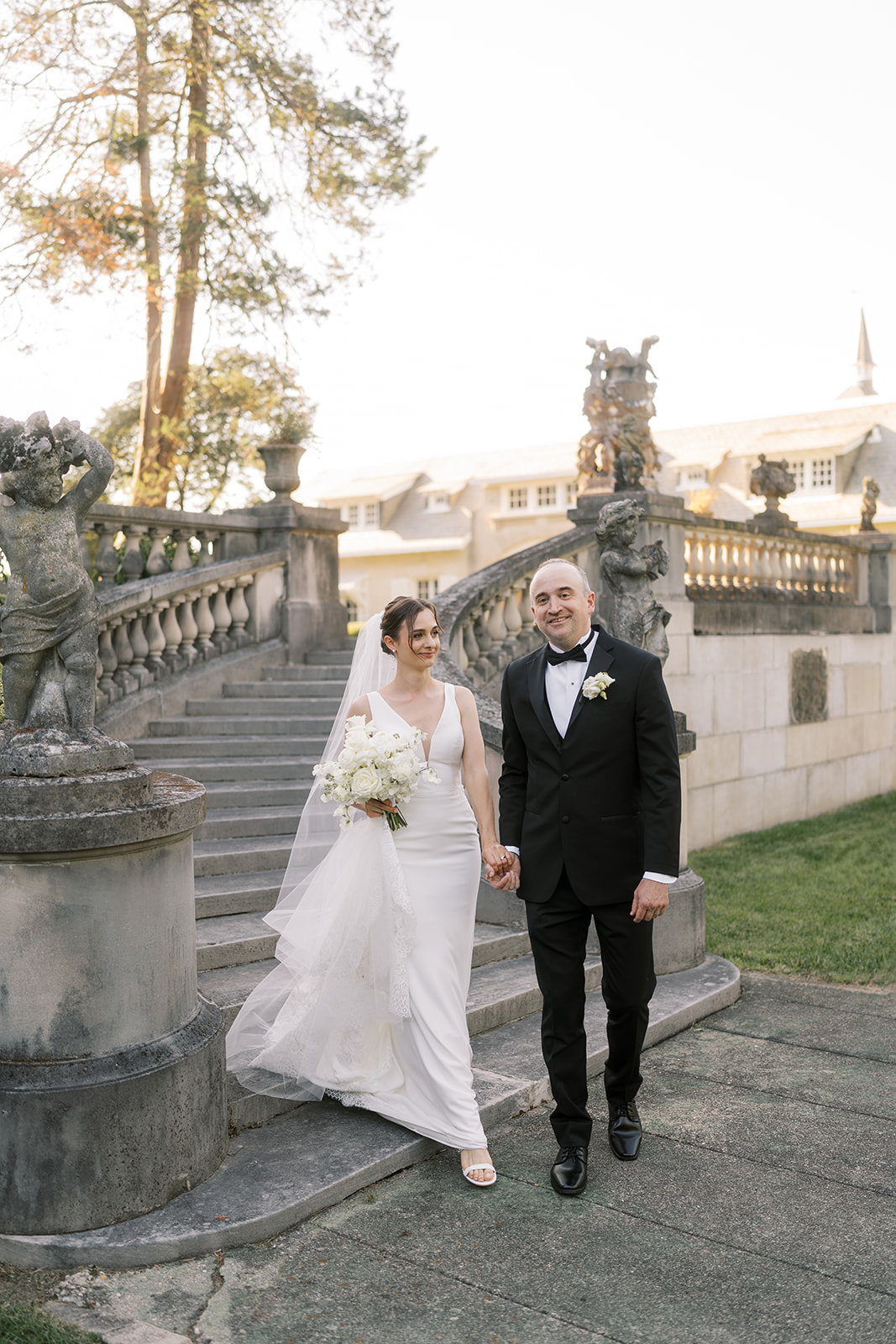 Michael and Julia walking together through the sunlit Laurel Court gardens