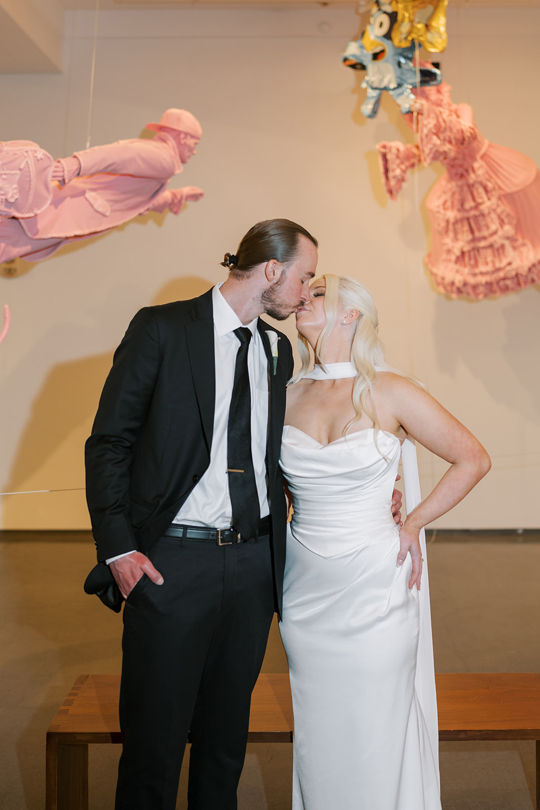 Close portrait of Niamh and Titus in front of pink contemporary artwork at 21c Museum Hotel Cincinnati