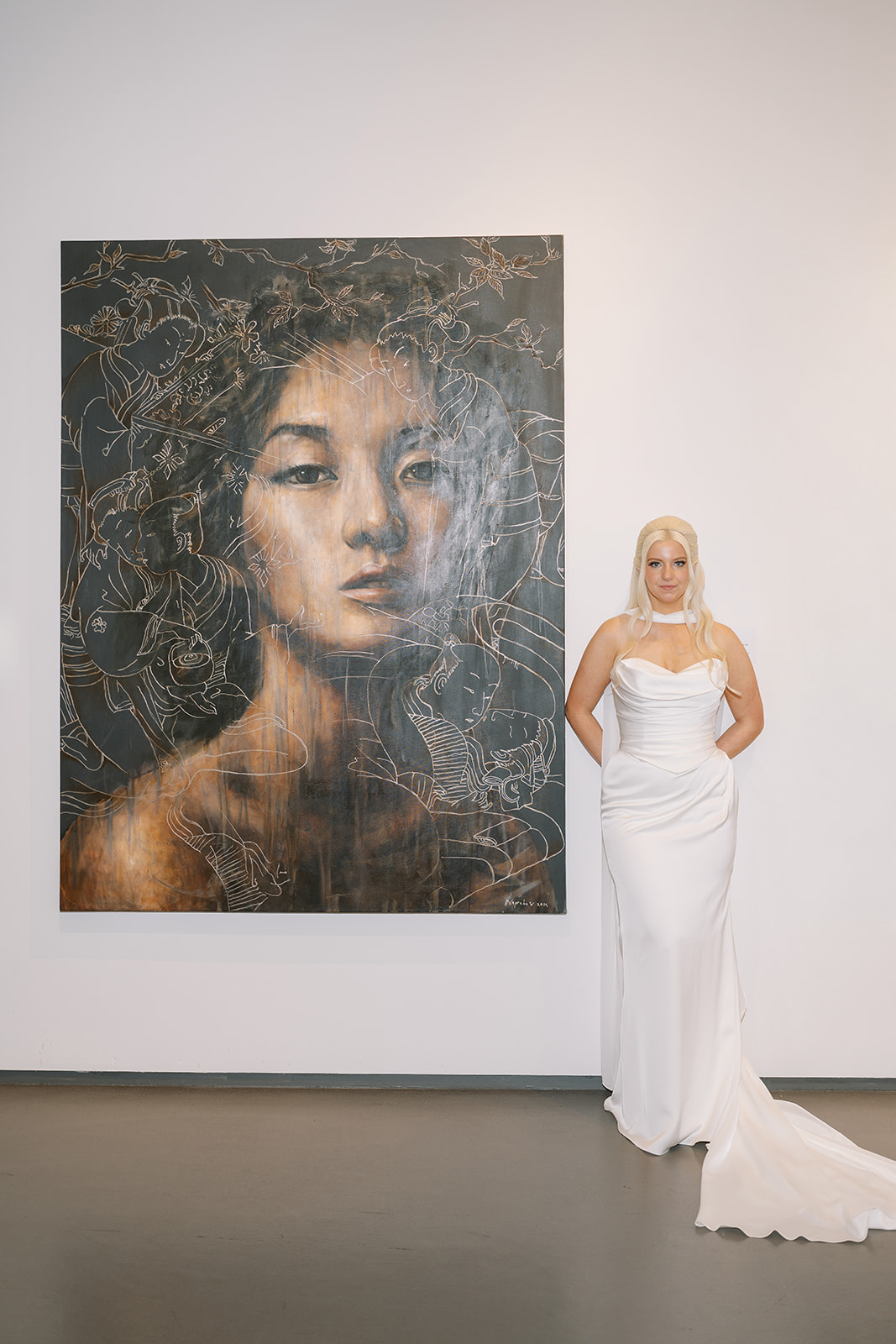 Niamh posing beside contemporary portrait artwork at 21c Museum Hotel Cincinnati