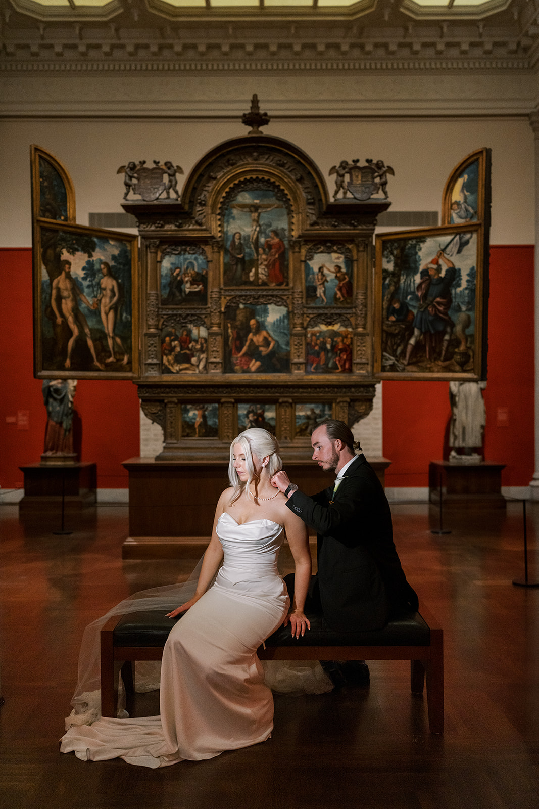 Niamh and Titus seated together in front of historic artwork at Cincinnati Art Museum
