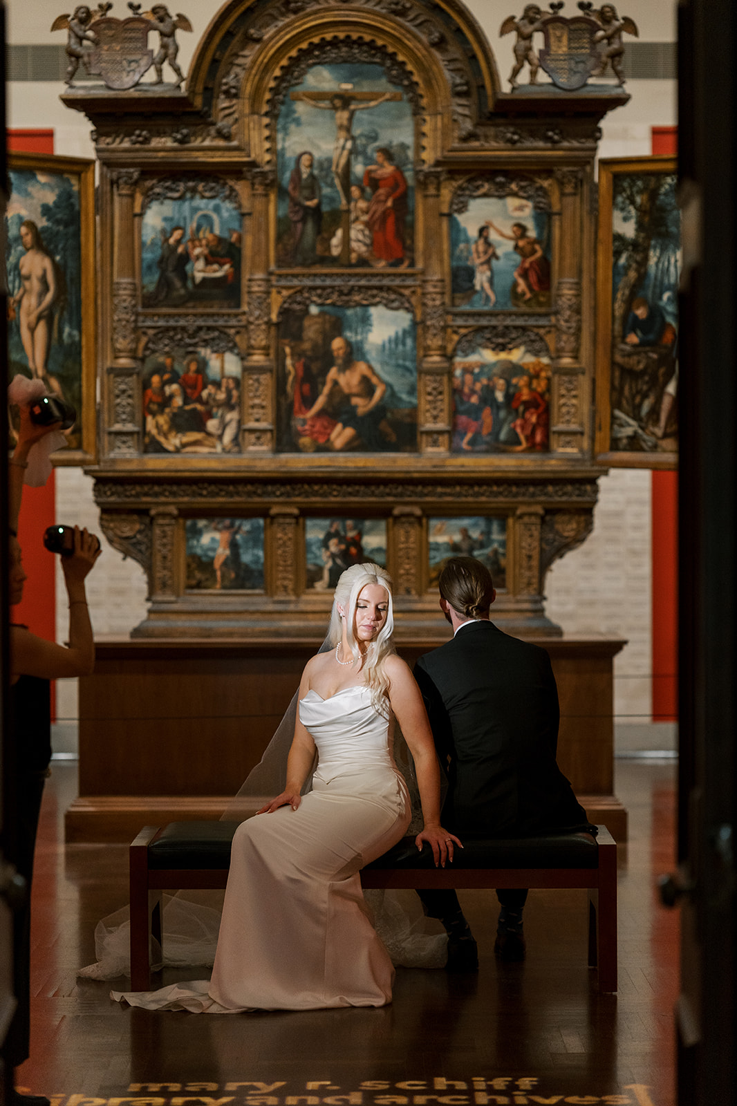 Niamh and Titus seated in front of historic artwork at Cincinnati Art Museum