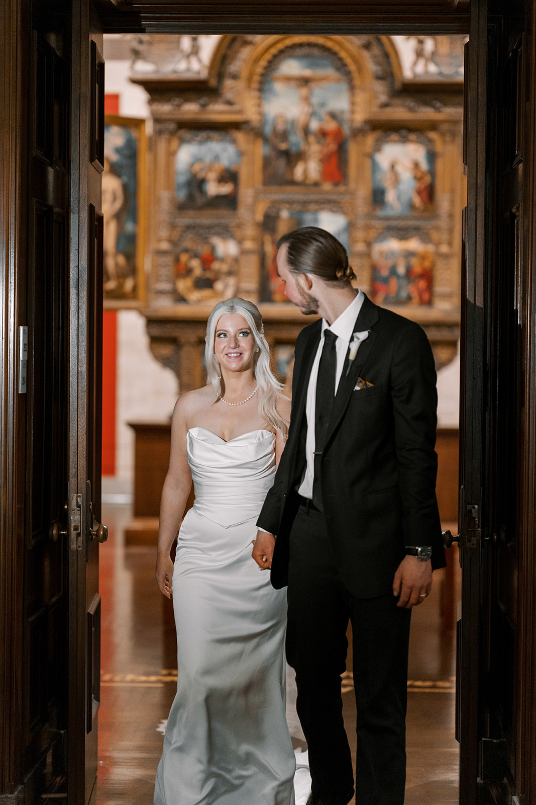 Niamh and Titus walking through a gallery doorway at Cincinnati Art Museum