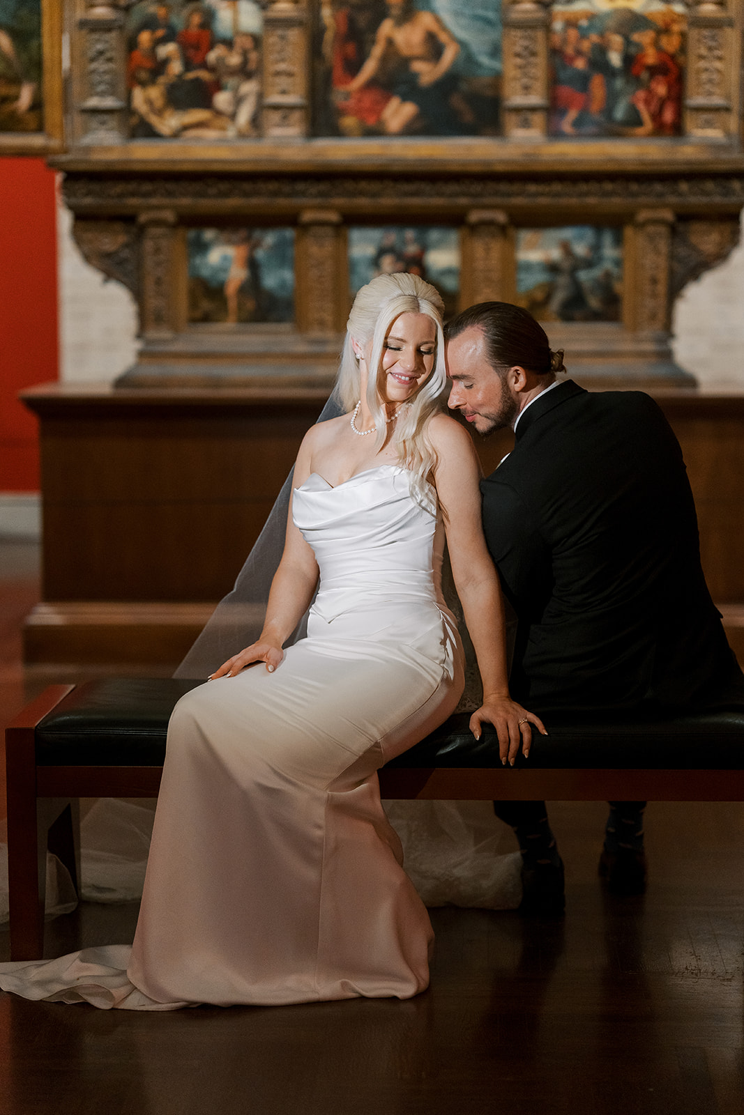 Niamh and Titus seated together in a gallery at Cincinnati Art Museum