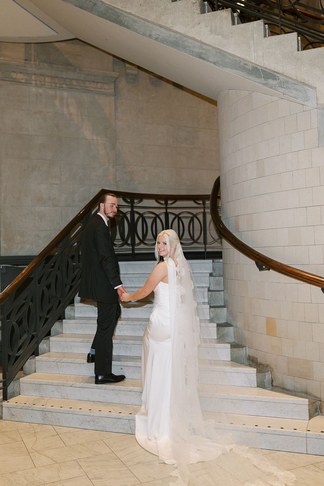 Niamh and Titus together on a stone staircase inside Cincinnati Art Museum