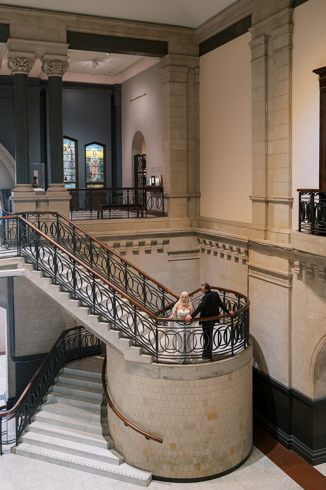 Wide architectural view of Niamh and Titus on Cincinnati Art Museum's staircase