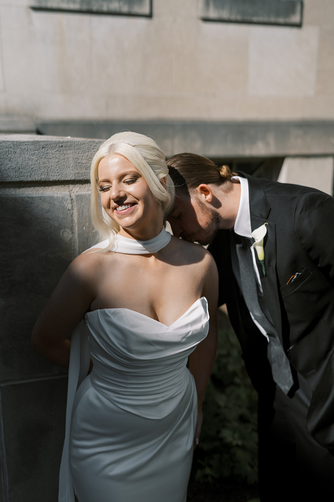 Titus kissing Niamh in warm sunlight outside Cincinnati Art Museum
