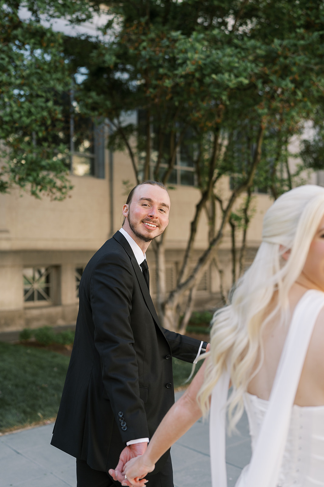 Titus smiling toward Niamh during portraits outside Cincinnati Art Museum