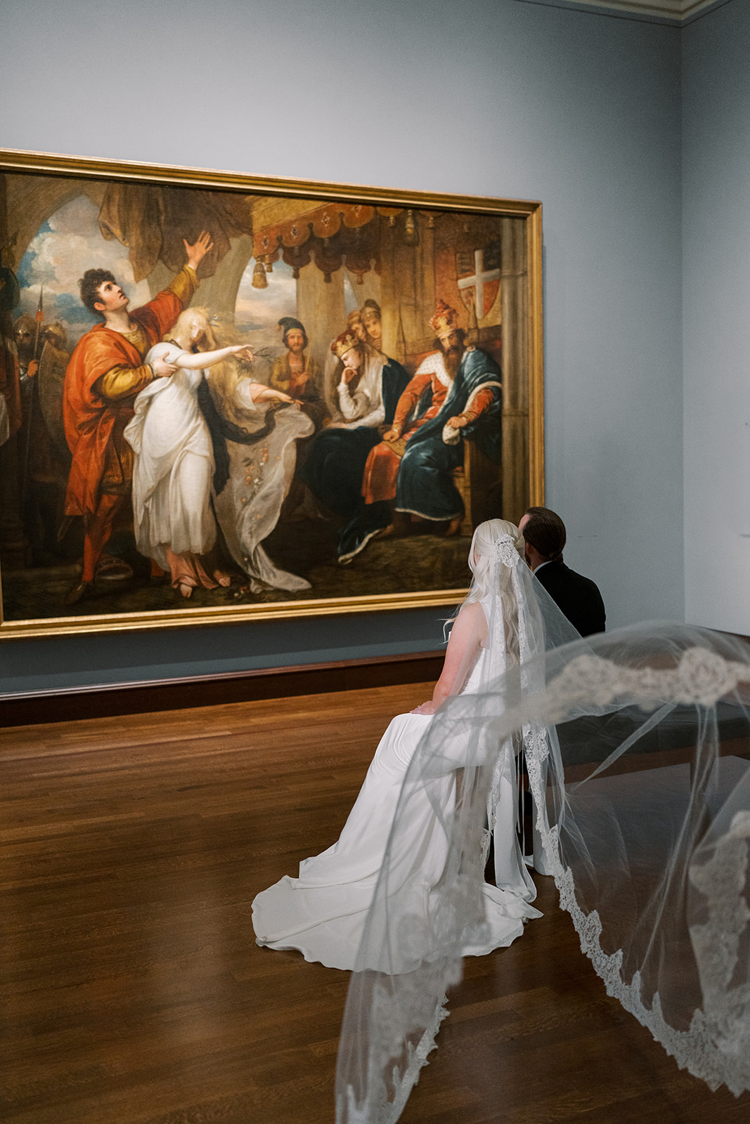 Niamh with her veil extended in front of a large painting at Cincinnati Art Museum