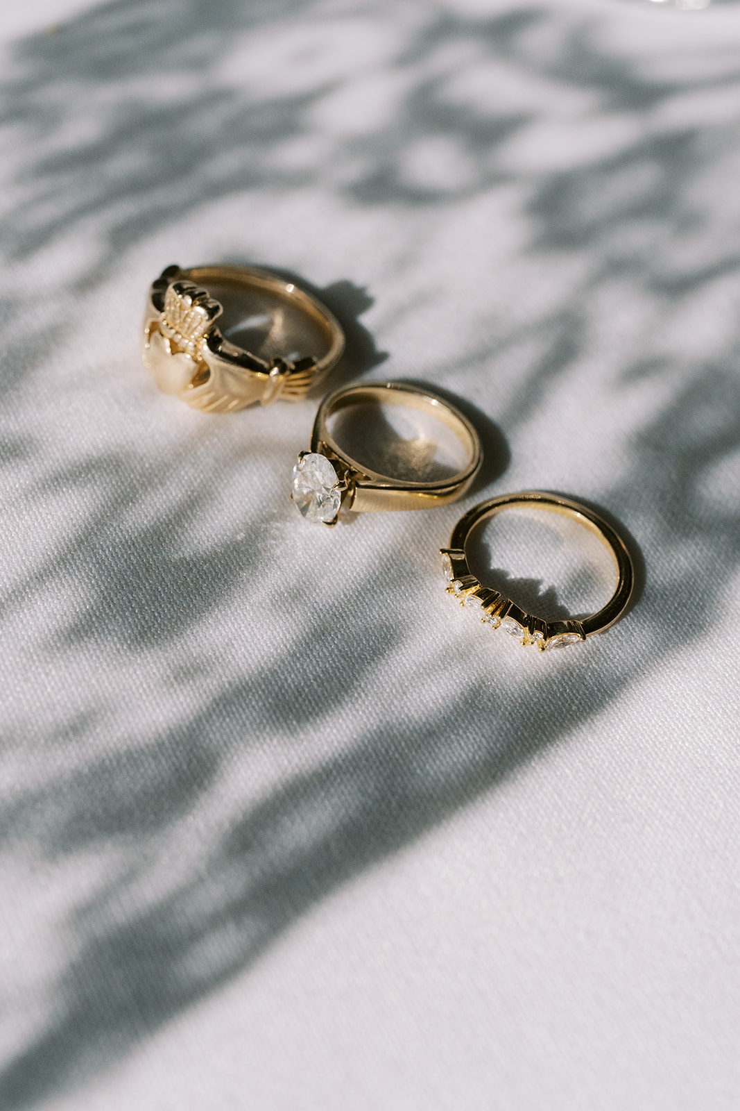 Niamh and Titus's wedding rings arranged in dappled light