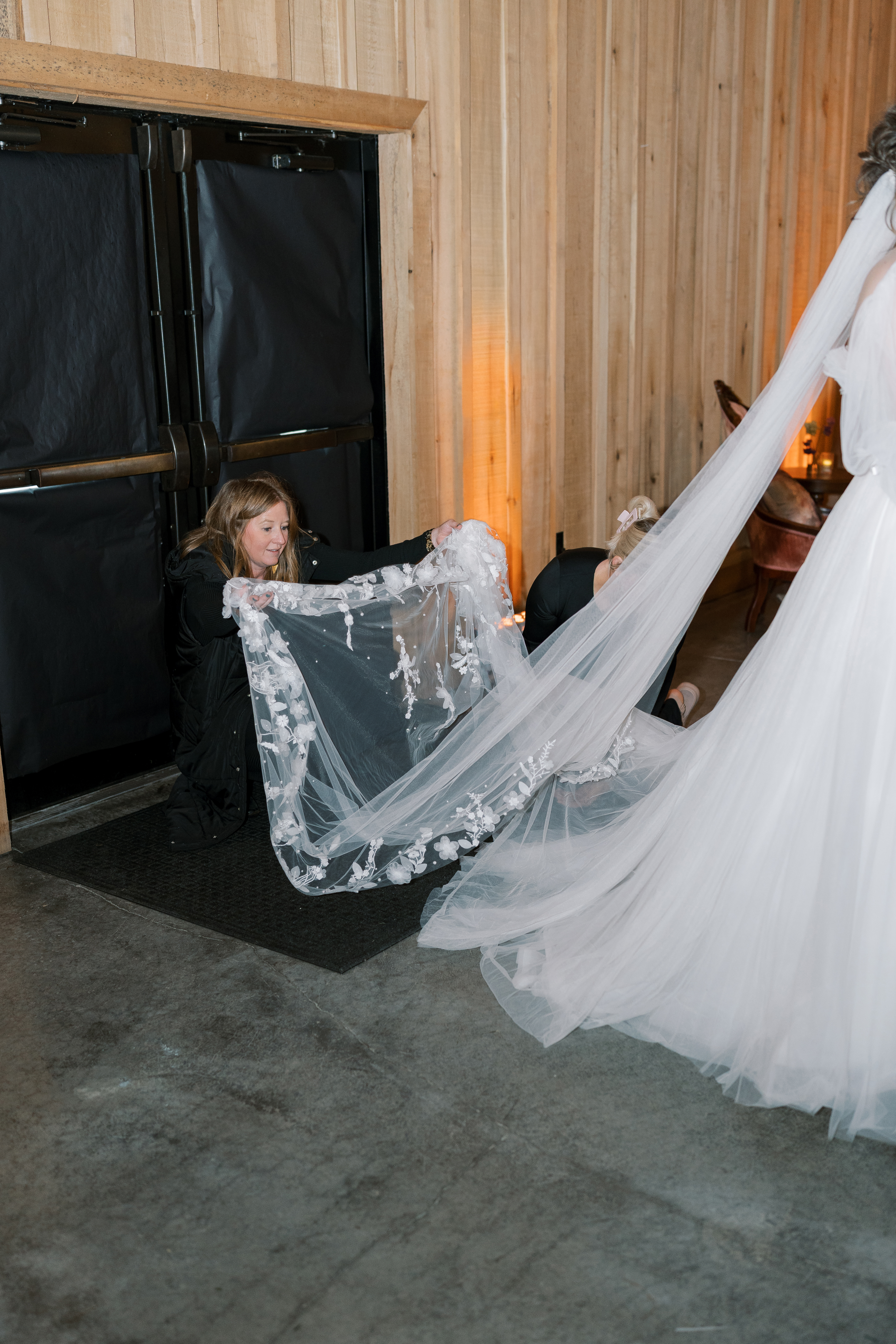 Leeann McKay helping arrange the bride’s veil and train during the wedding day