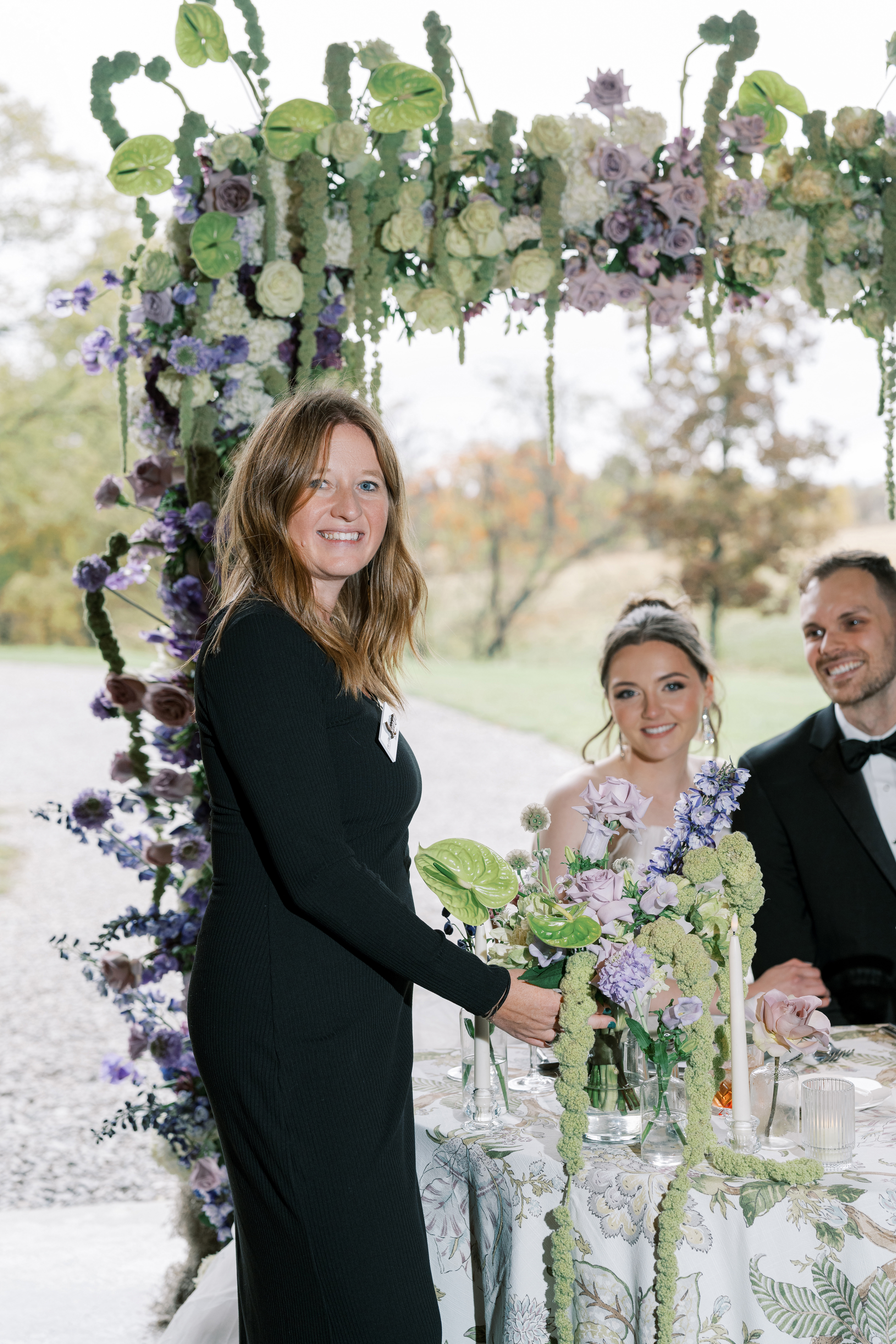 Leeann McKay coordinating beside the couple at the sweetheart table