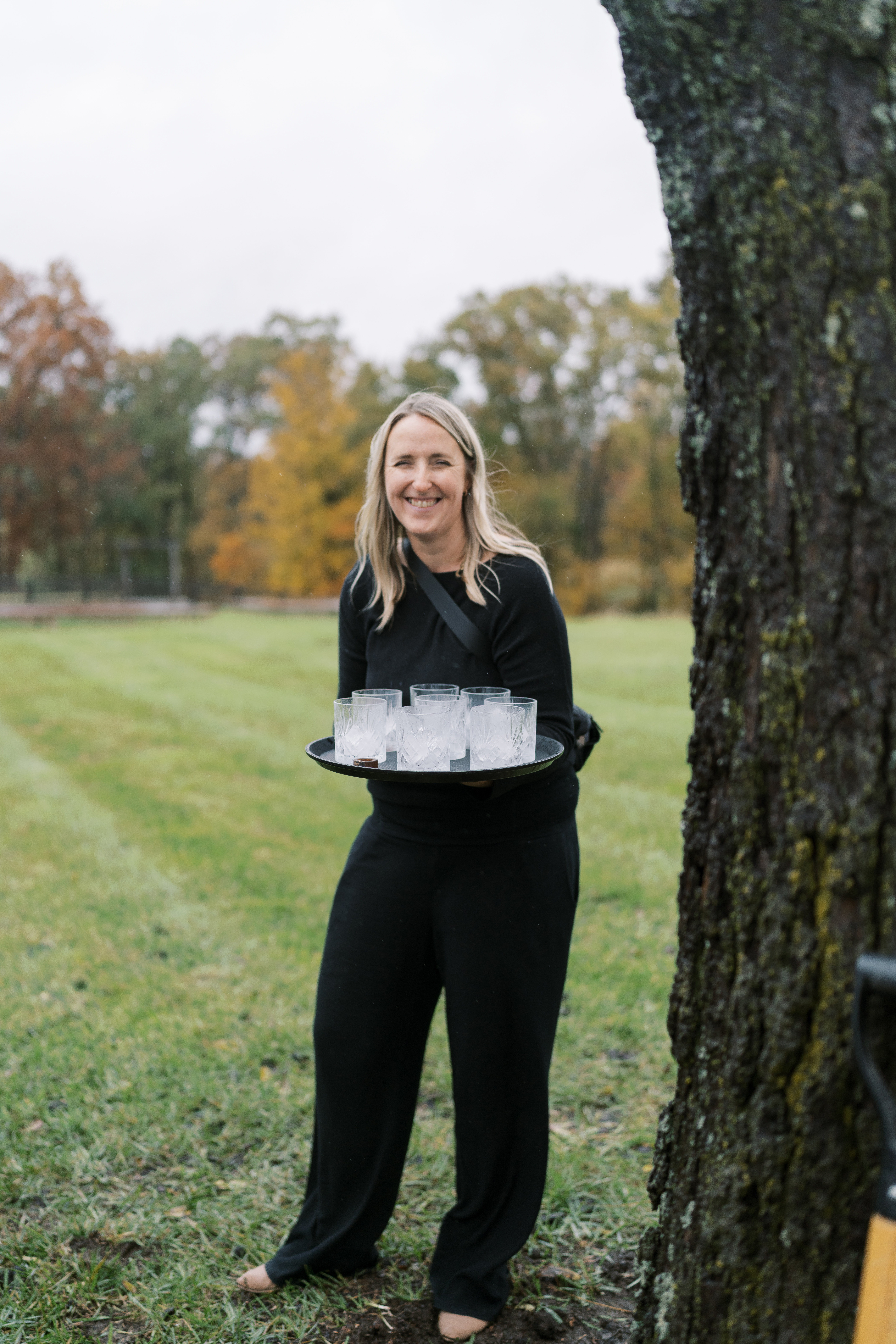 Leeann McKay carrying wedding-day details outdoors during event coordination