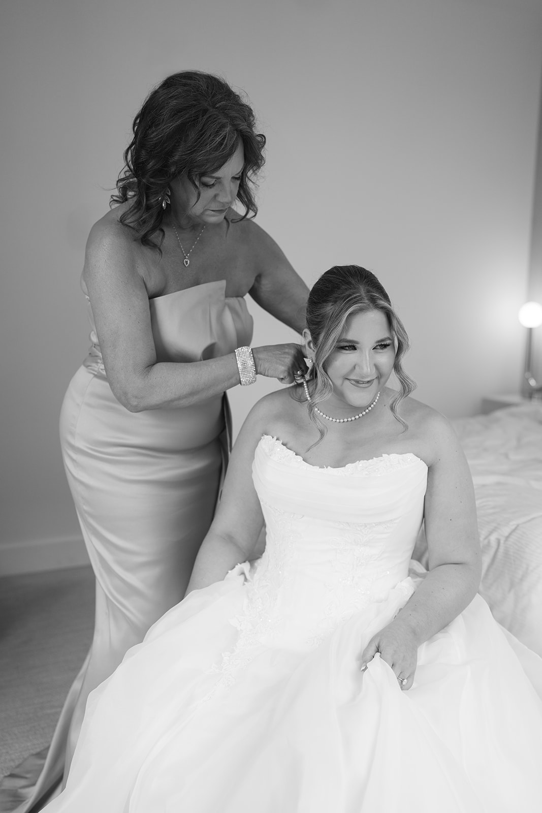 Black-and-white photograph of Hannalee having her hair finished before the ceremony