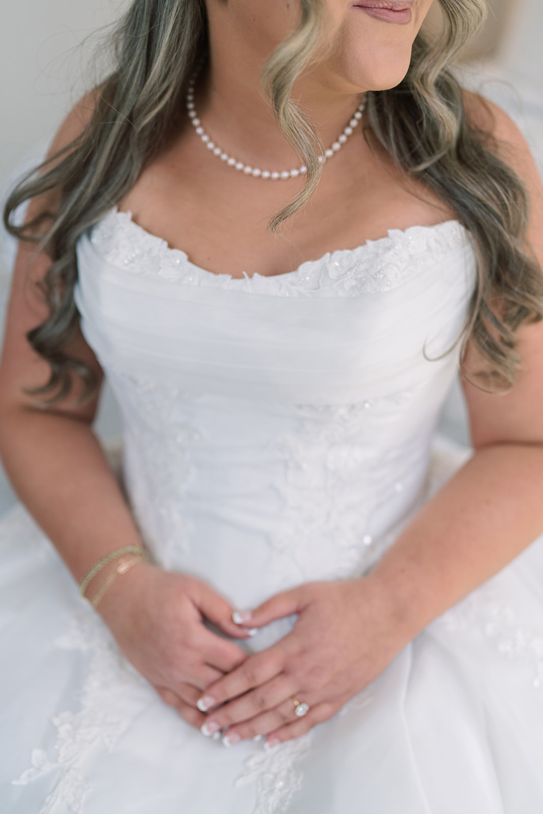 Close bridal portrait showing Hannalee's pearl necklace and wedding gown