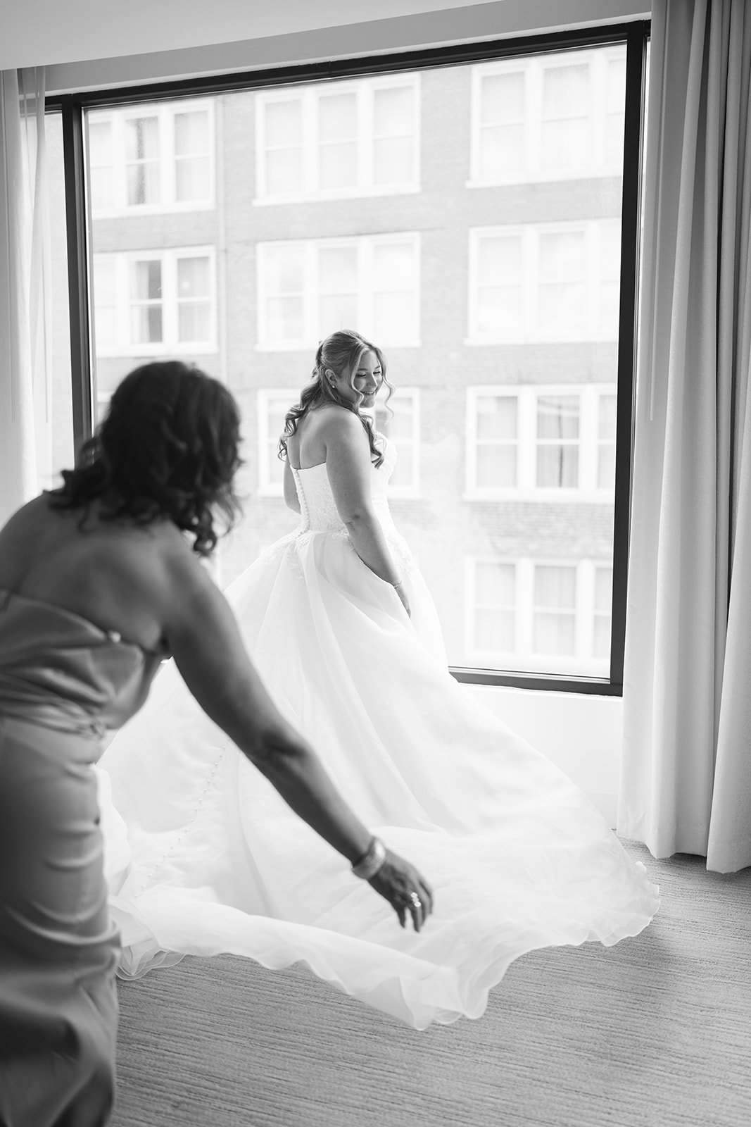 Hannalee standing by a bright window while getting ready