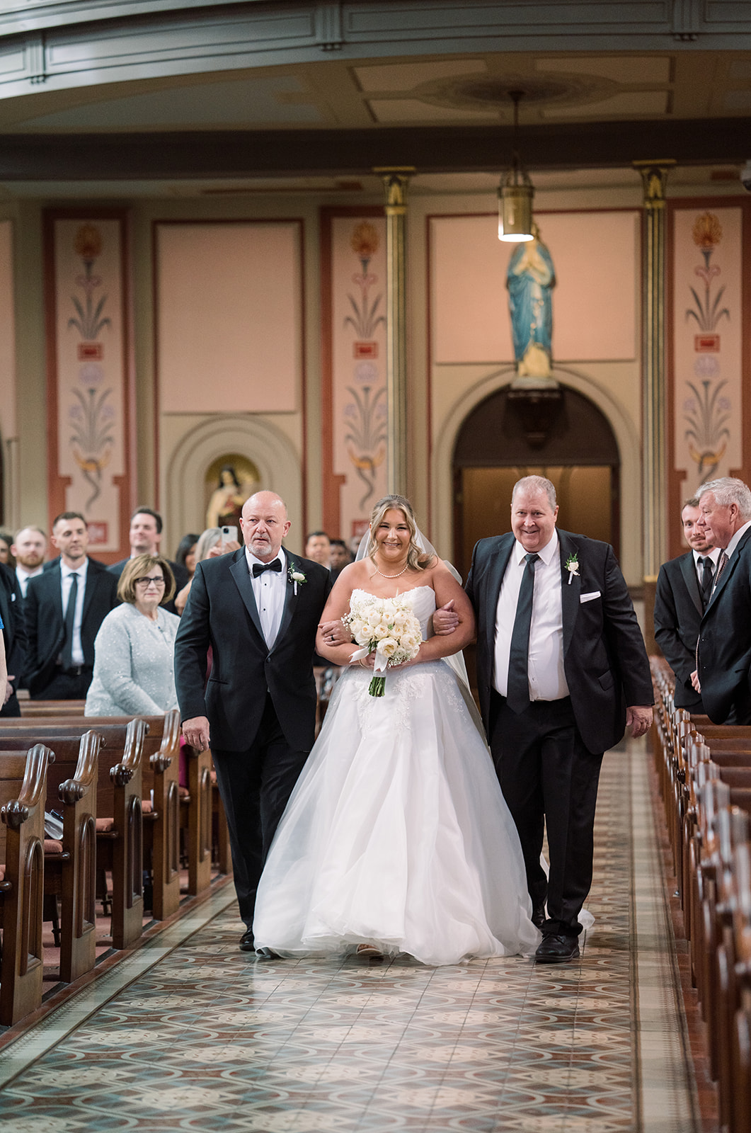 Hannalee walking down the aisle inside Mother of God Church