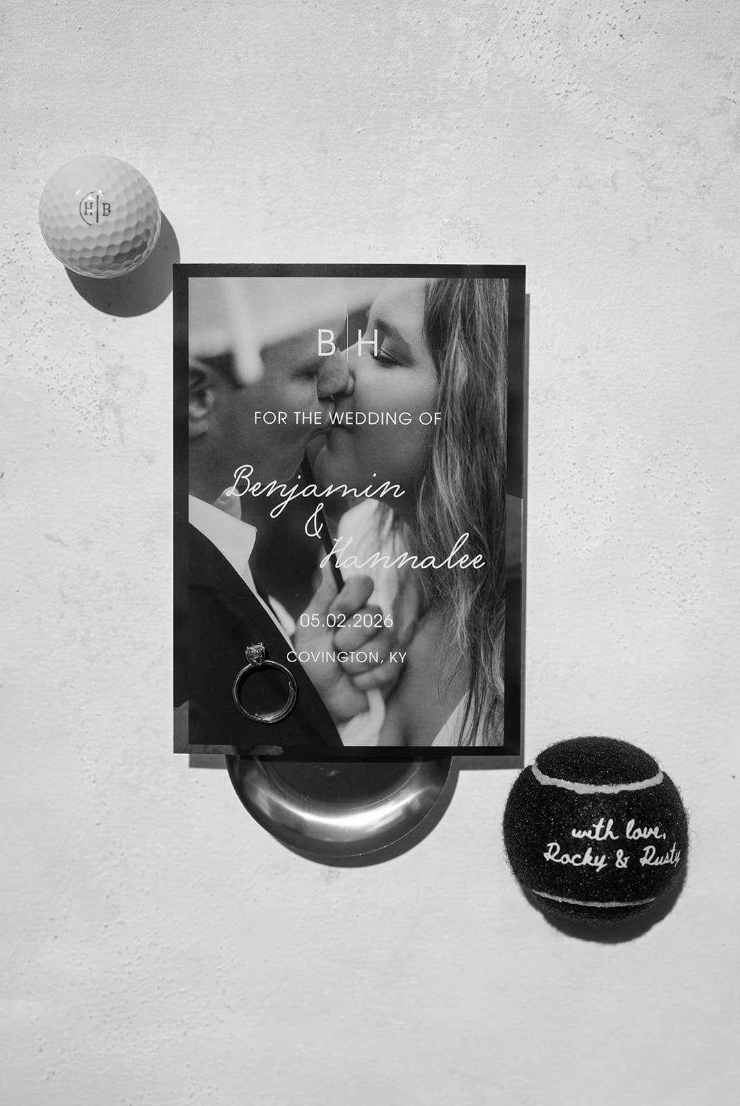 Ben and Hannalee's wedding stationery, ring and monogrammed golf ball