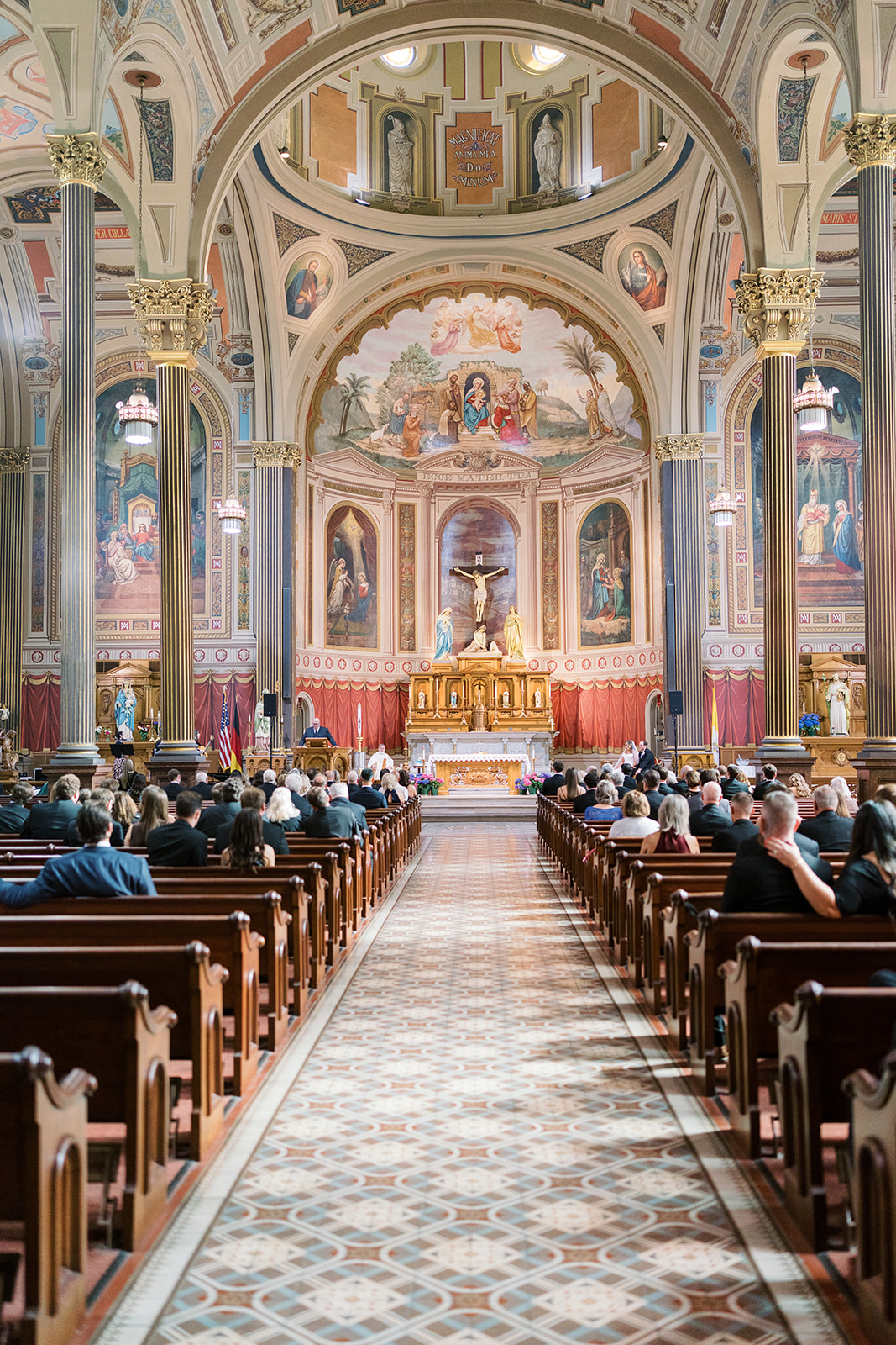 Center-aisle view of the ceremony inside Mother of God Church