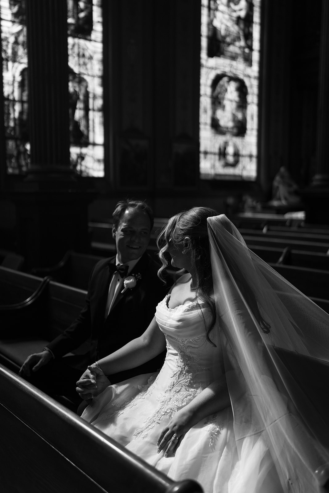 Black-and-white portrait of Ben and Hannalee seated together inside Mother of God Church