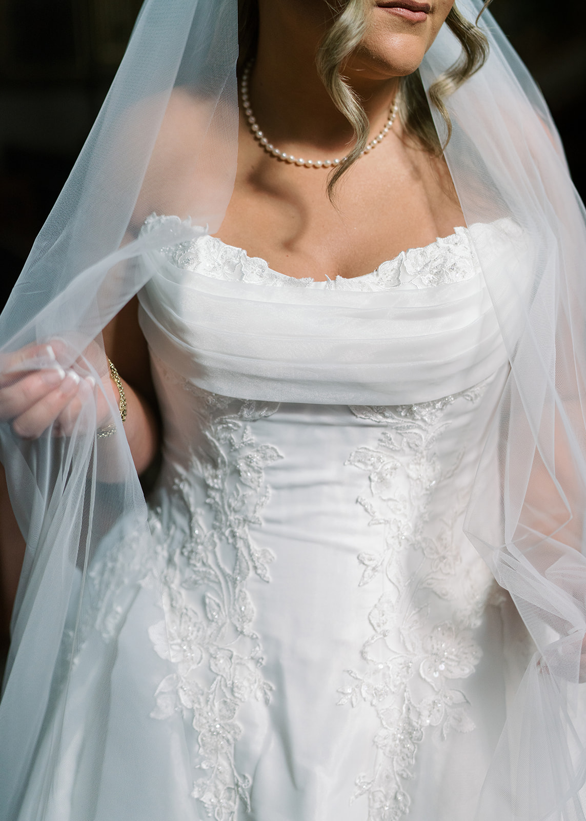 Close bridal portrait of Hannalee's gown and veil