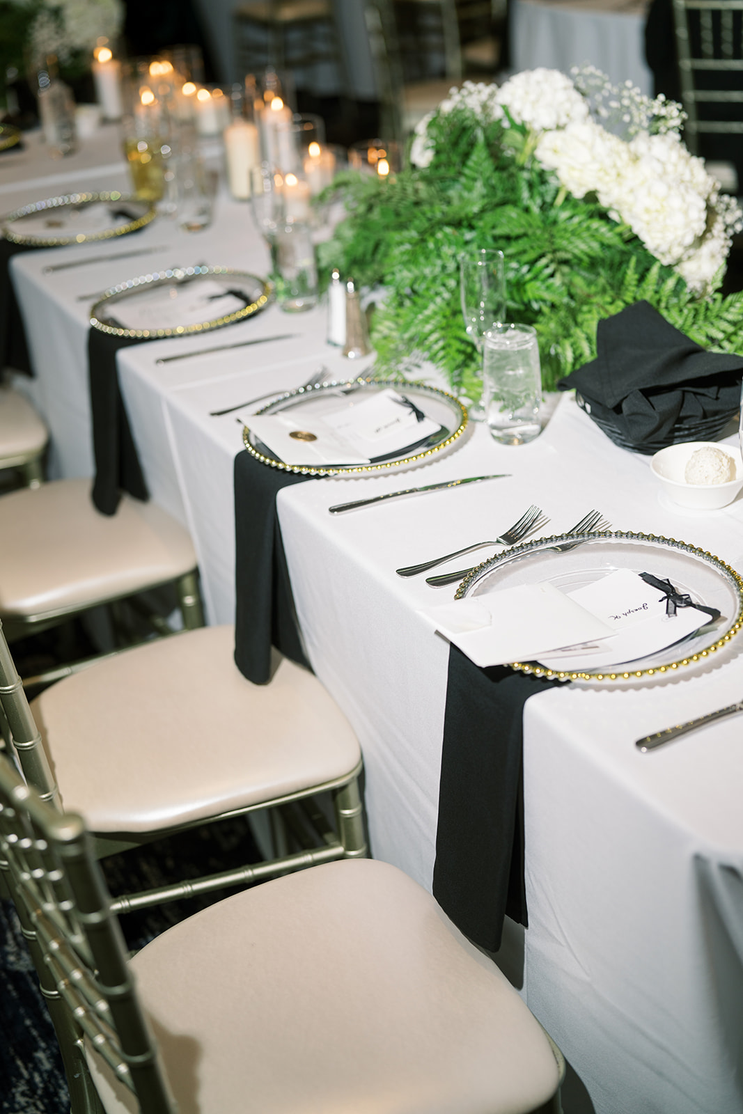 White, black and green reception table design with candles at Hotel Covington