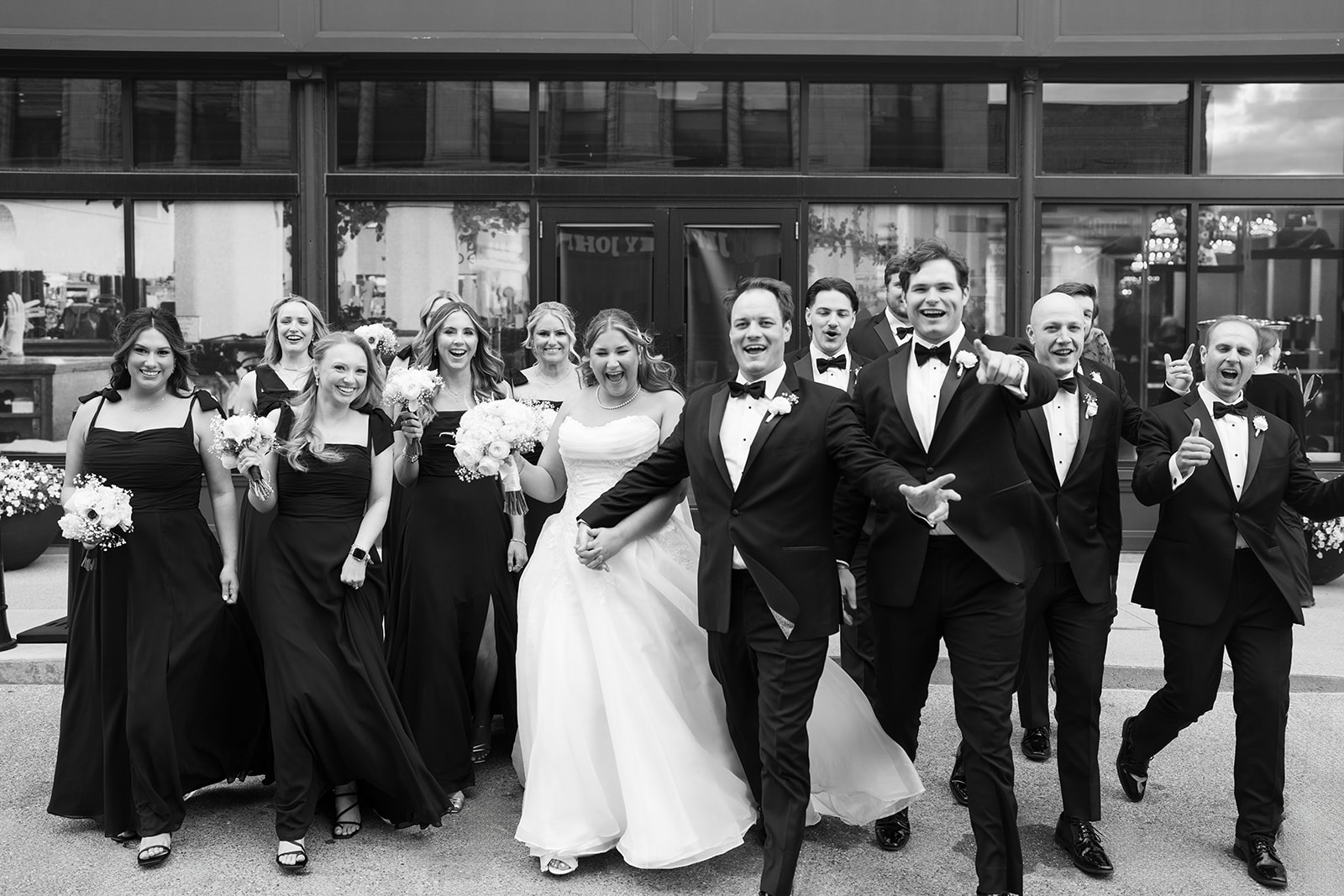 Ben, Hannalee and their wedding party celebrating outside Hotel Covington