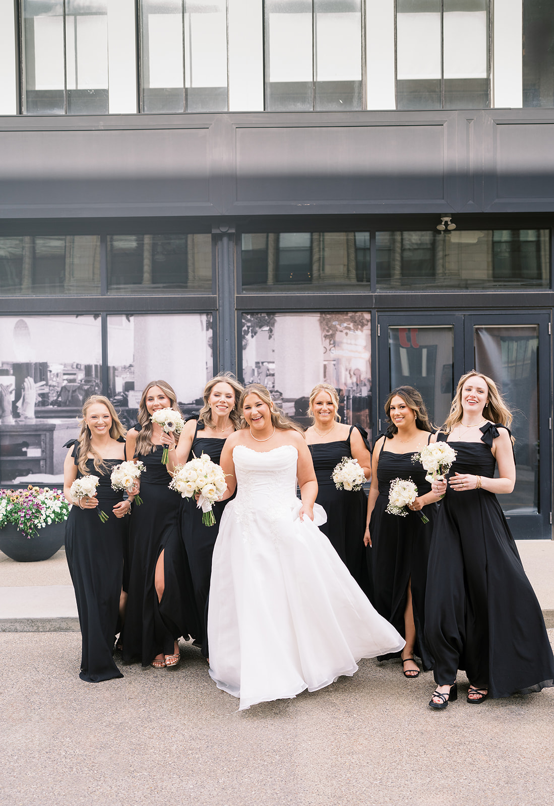 Hannalee with her bridesmaids in black dresses outside Hotel Covington