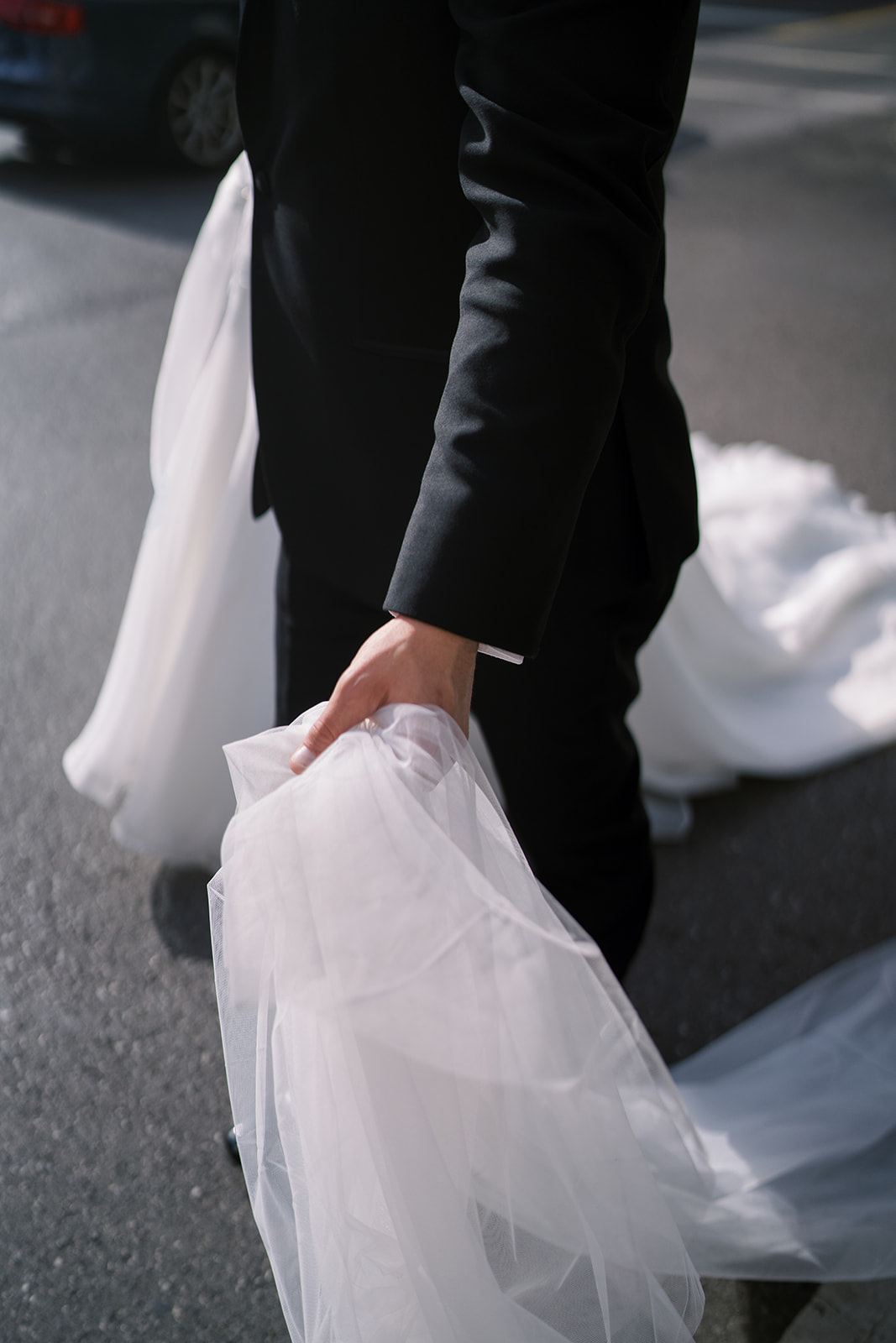 Close black-and-white detail of Ben holding Hannalee's veil