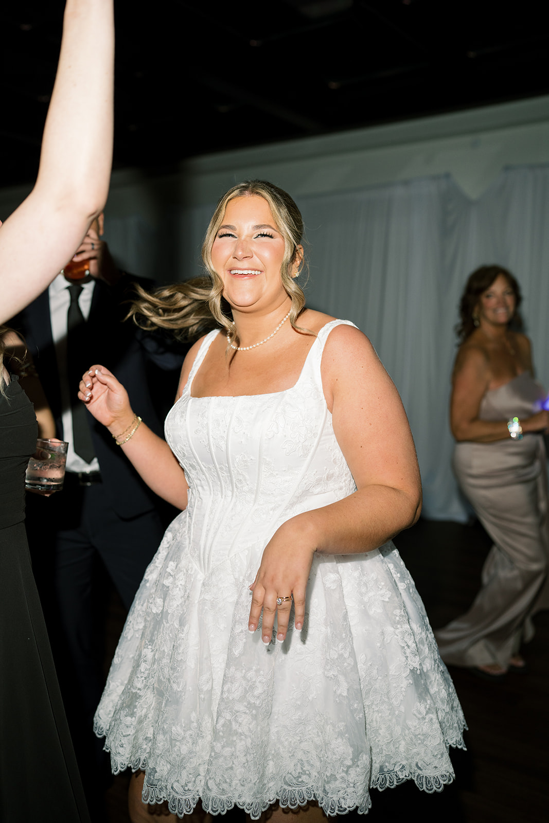 Hannalee dancing in her short white reception dress