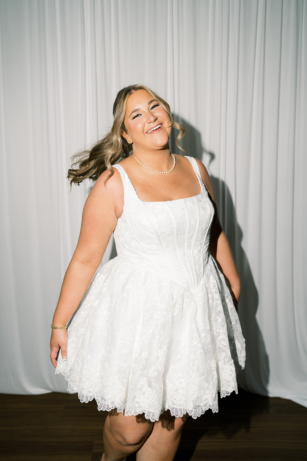 Hannalee smiling in her short white reception dress