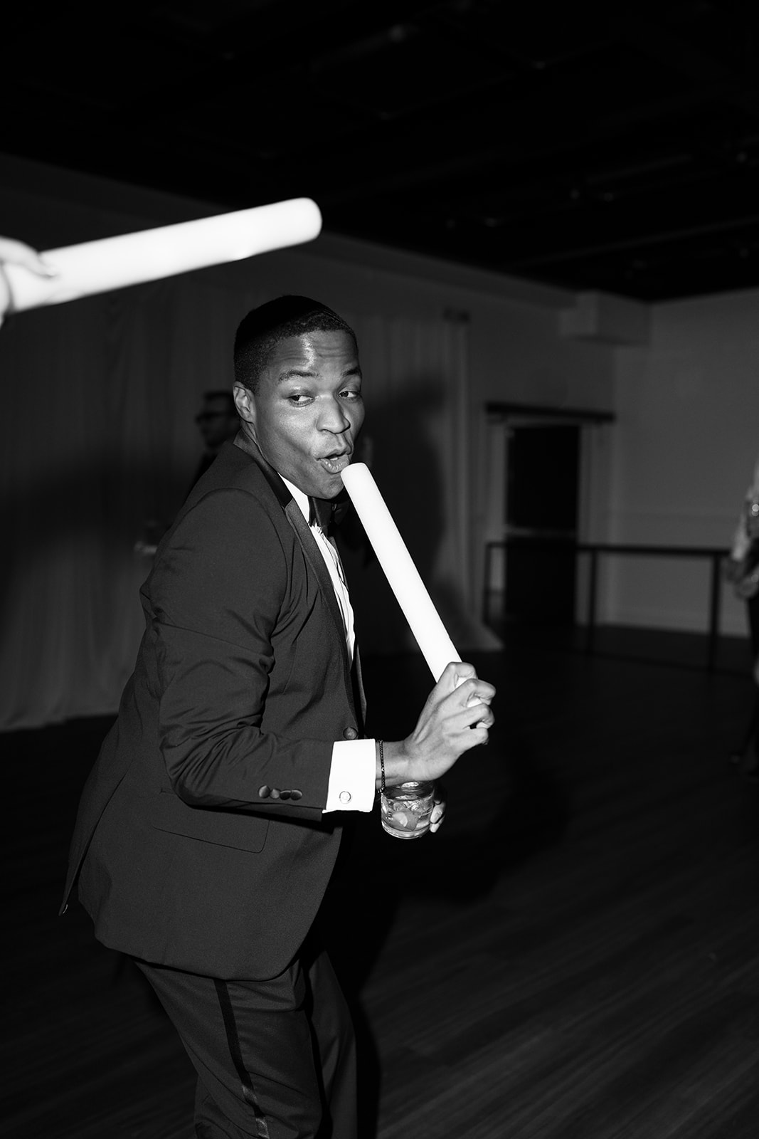 Wedding guest dancing with a glow stick during the reception