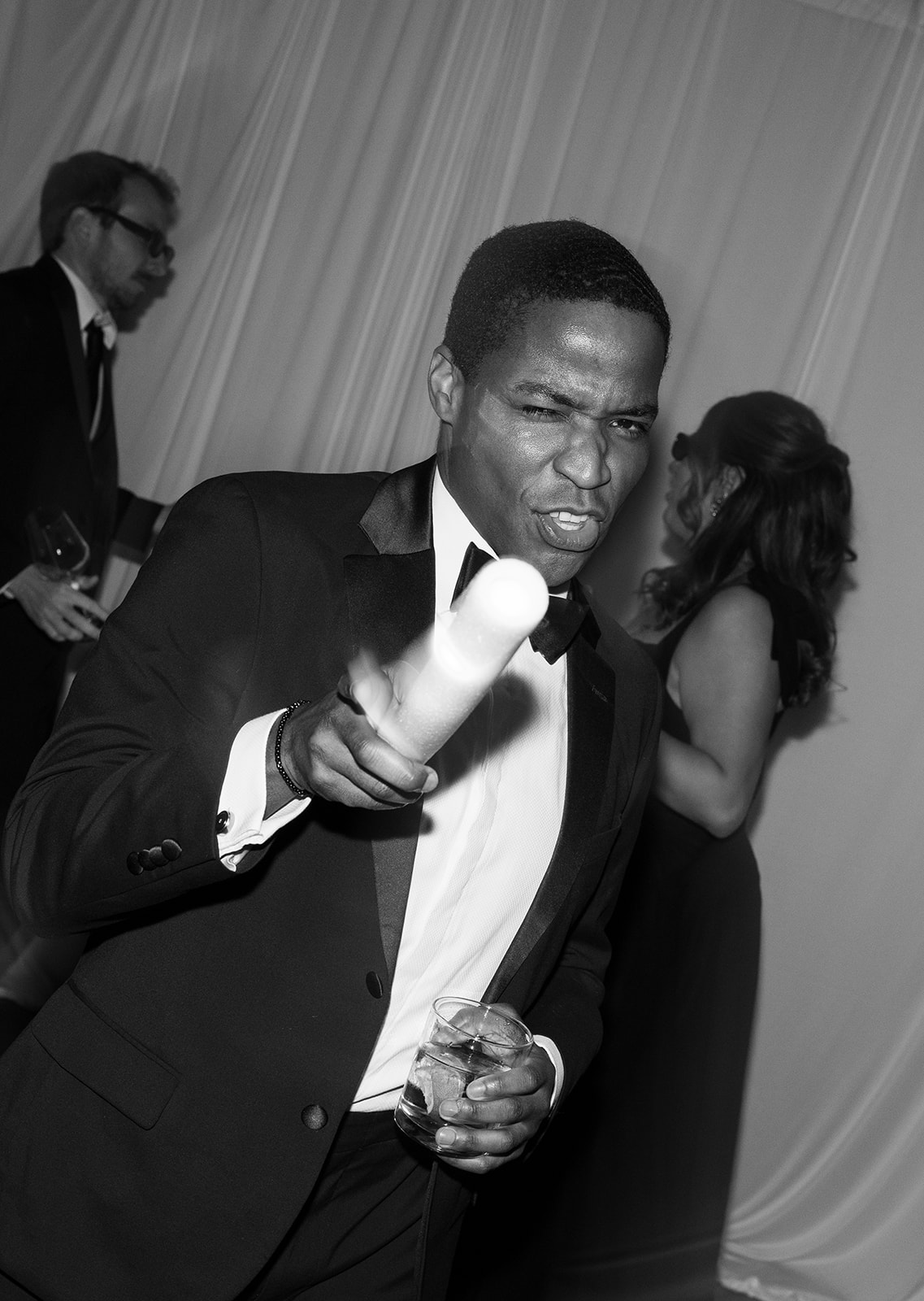 Black-and-white close-up of a guest dancing during the reception