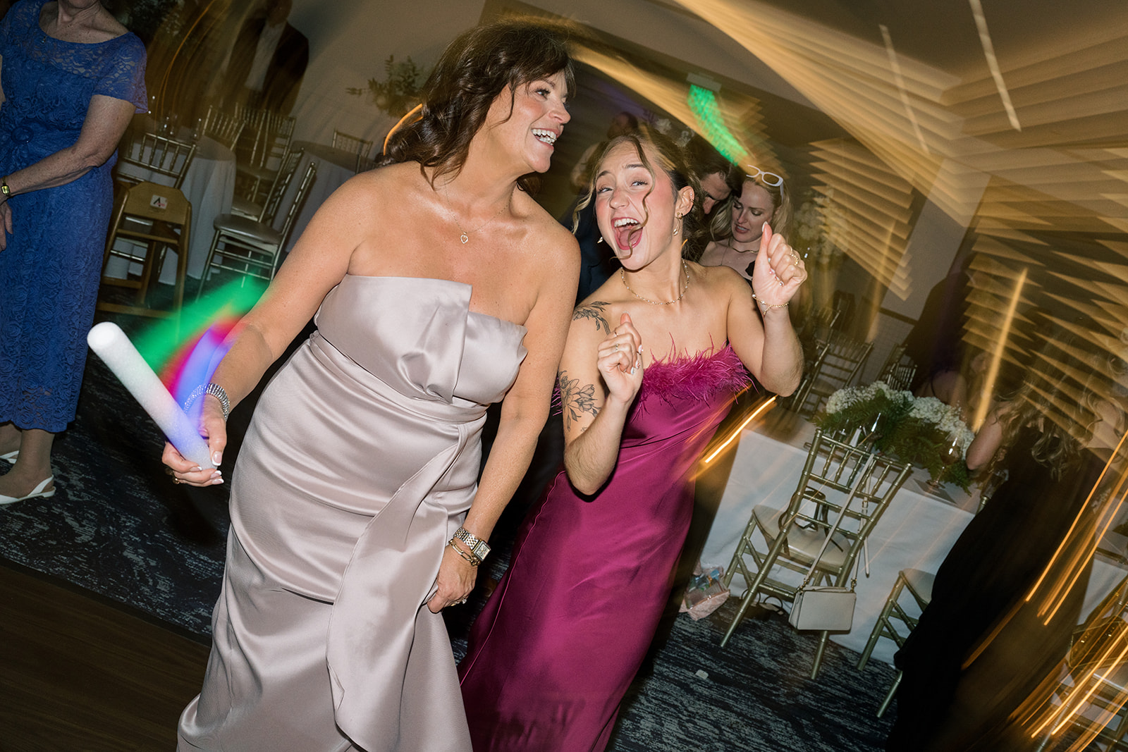 Wedding guests dancing together during the evening reception