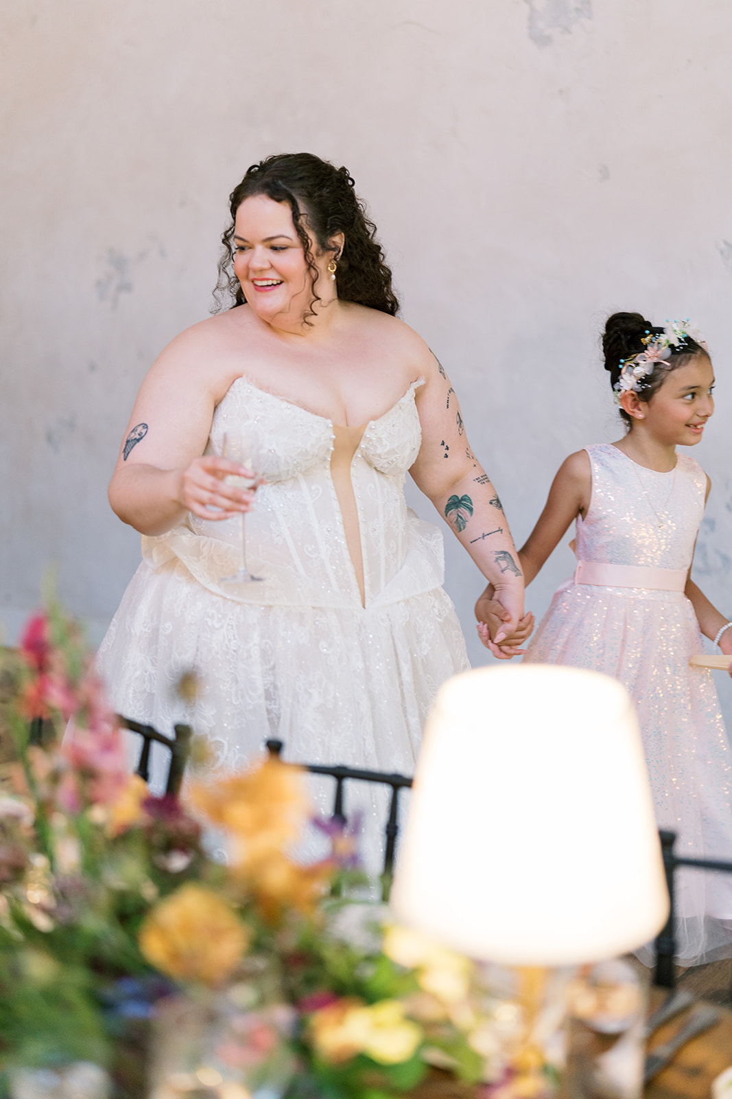 Bride laughing beside the reception tables at Terrain Gardens at DelVal