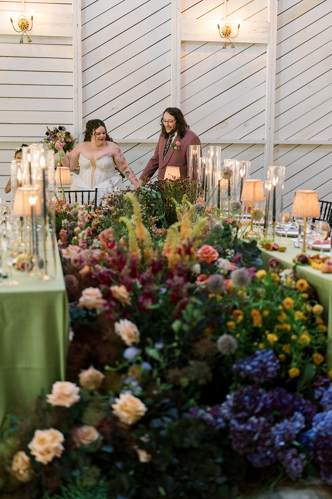 Colorful reception flowers beneath the venue's bright interior