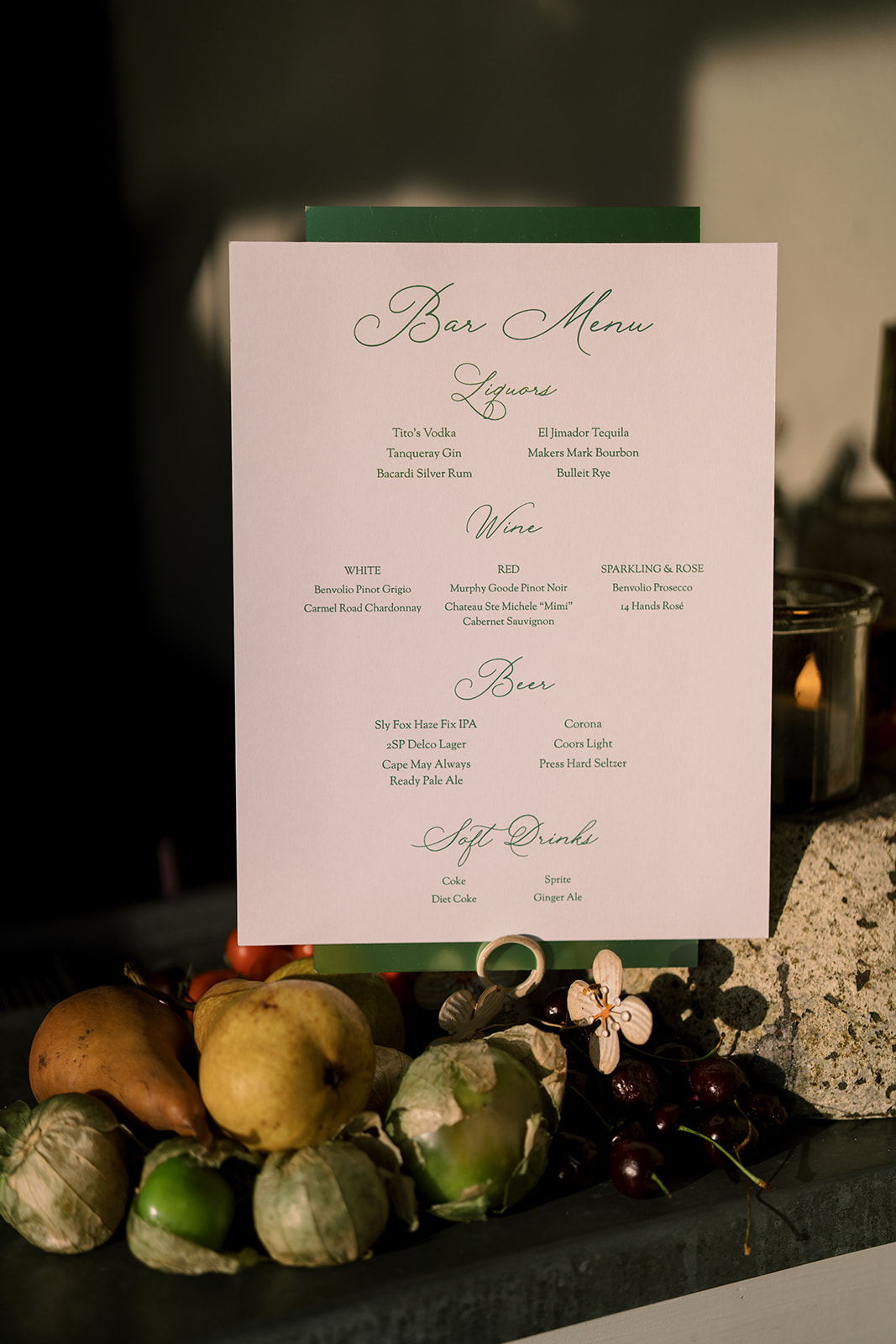 Wedding menu displayed among seasonal fruit and flowers