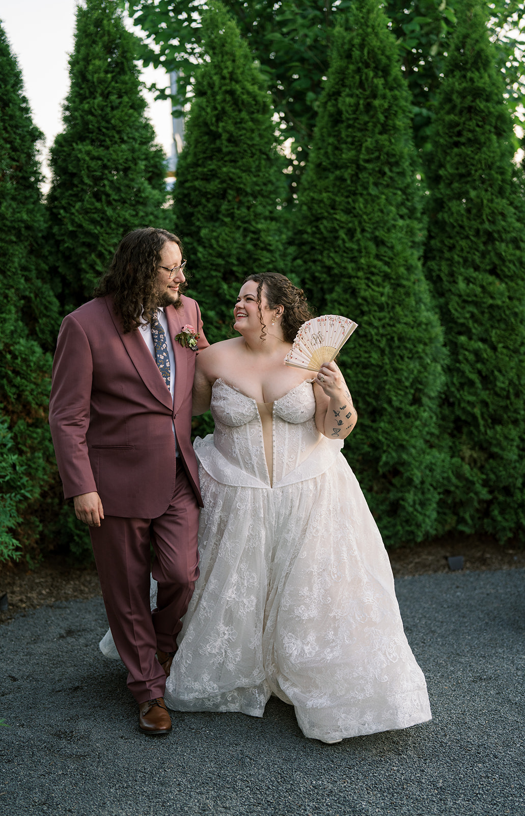 Jeff and Breanna together beside tall greenery outside Terrain Gardens at DelVal
