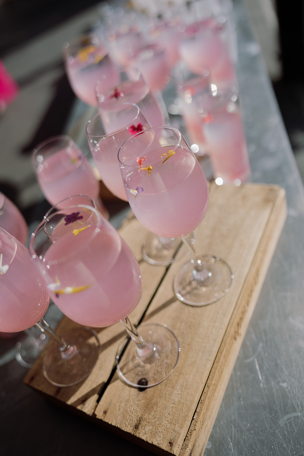 Pink signature drinks arranged for wedding guests