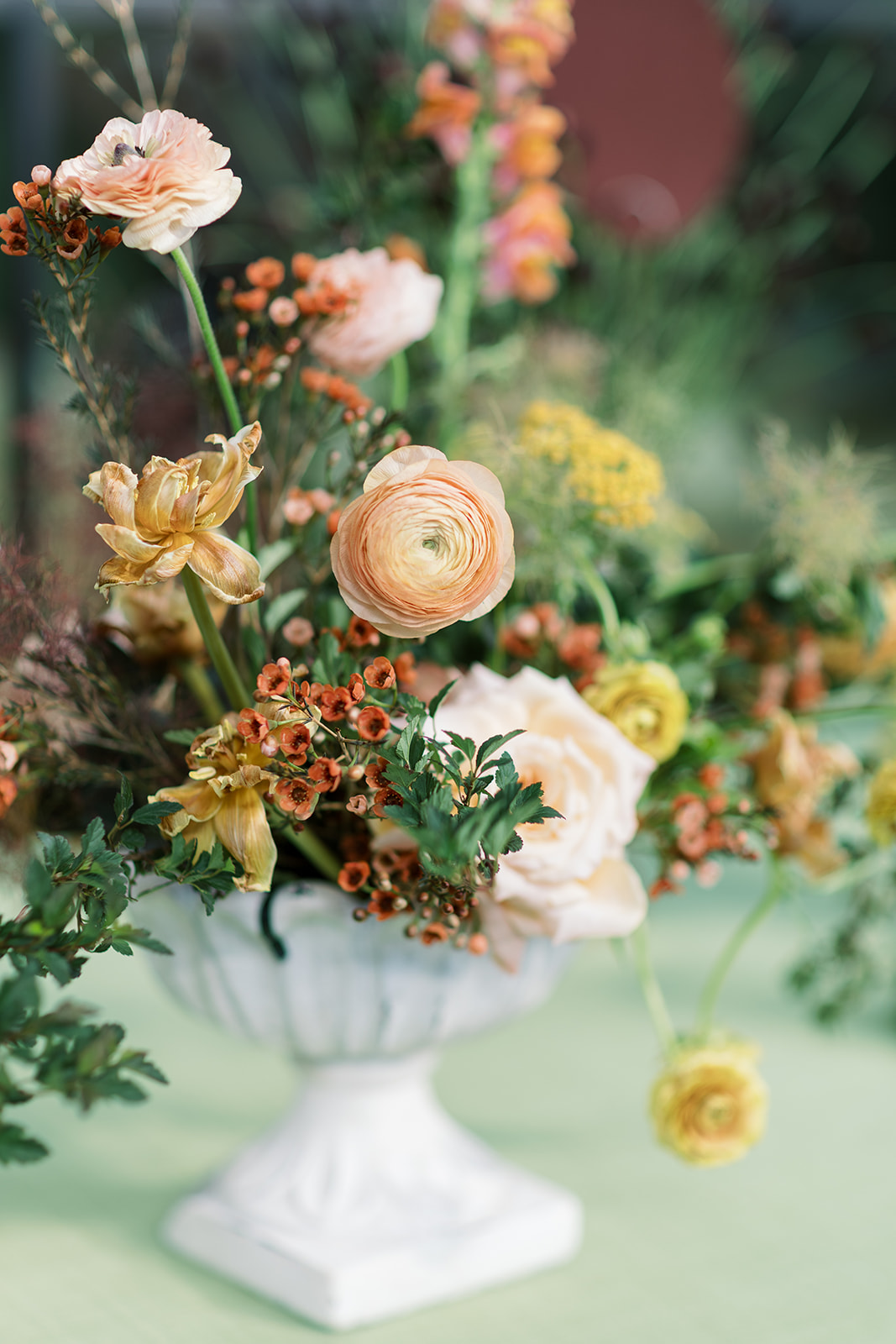 Garden-style floral arrangement in a stone vessel