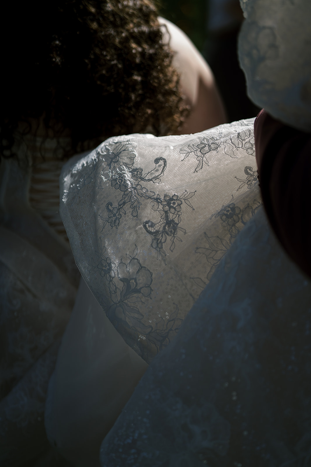 Close detail of the bride's lace wedding dress