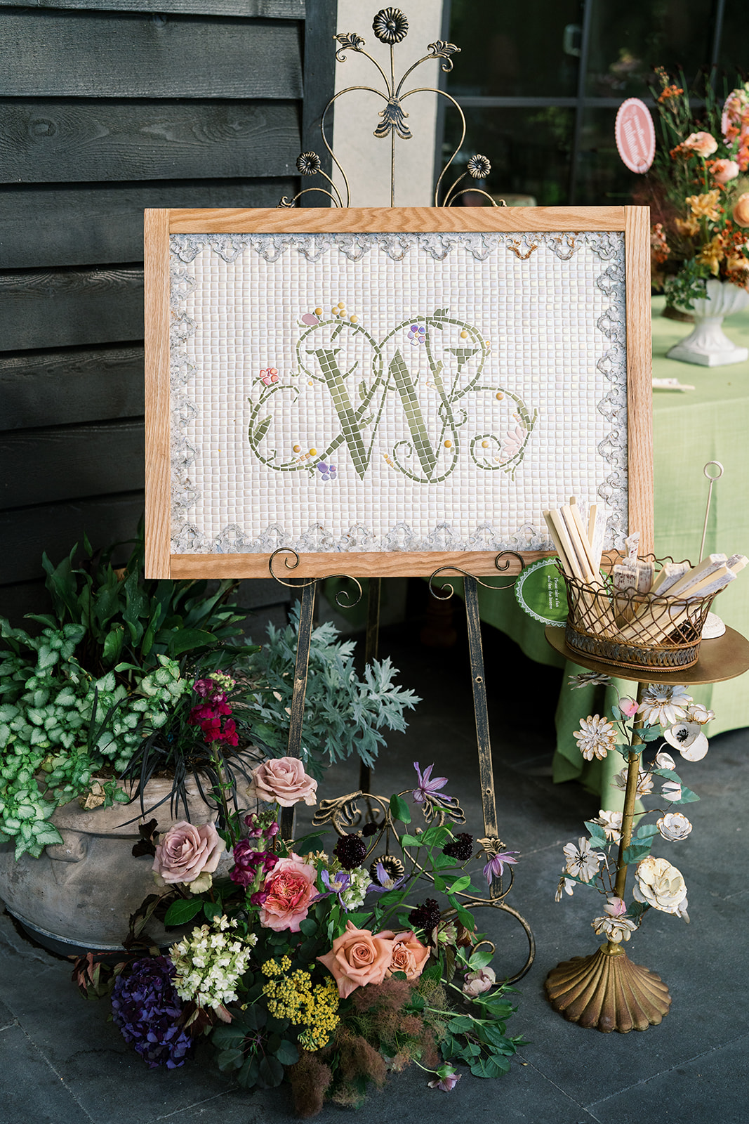 Wedding monogram sign displayed among flowers