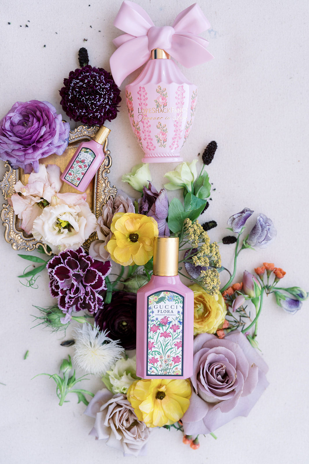 Wedding perfume and floral details arranged on a pale background