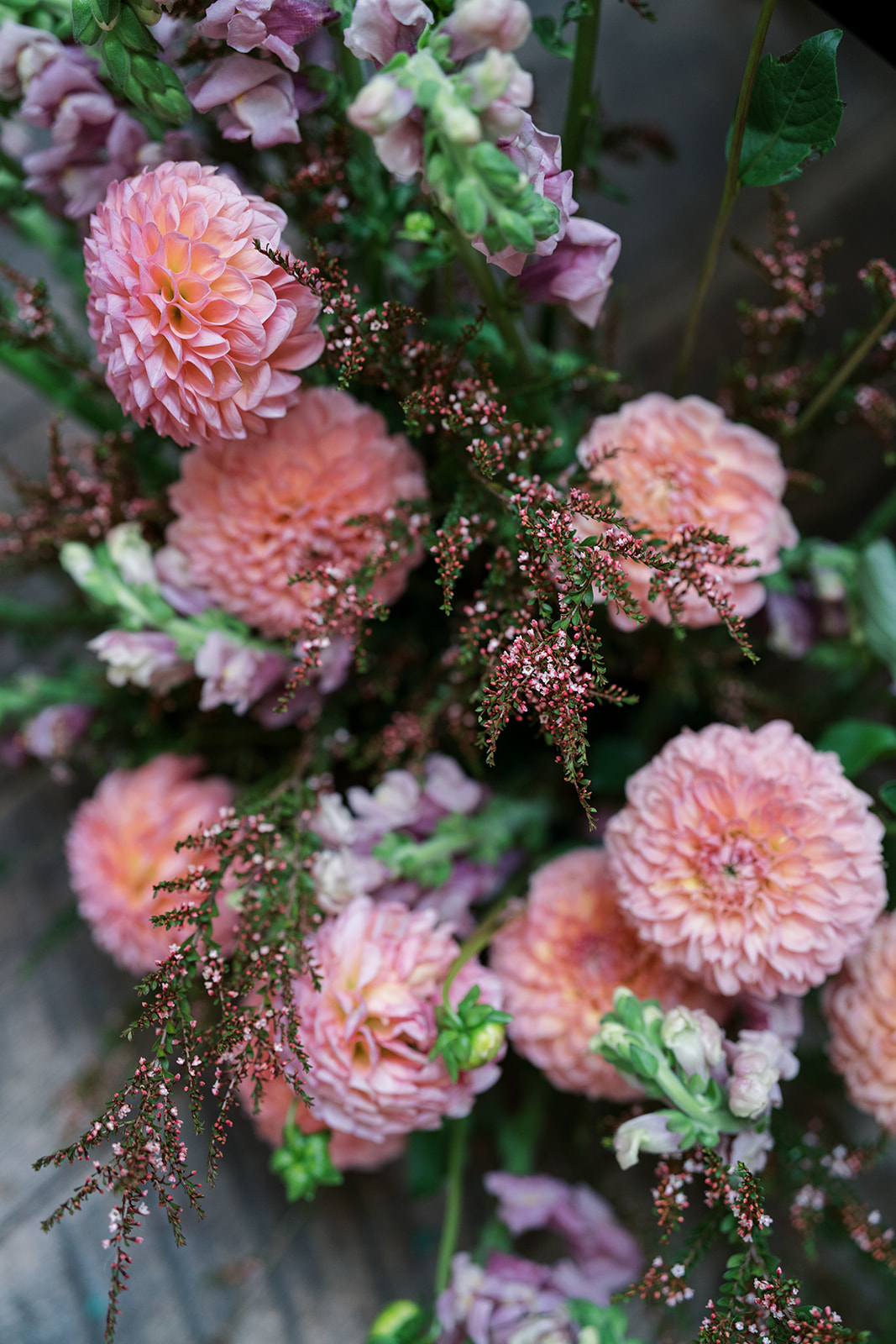 Pink pom-pom flowers and greenery in the wedding floral design